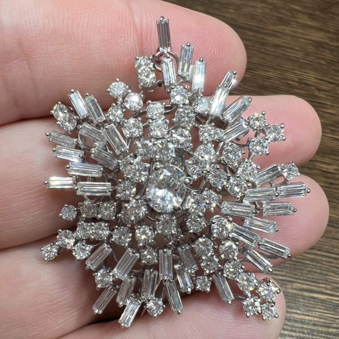 10 Ct Platinum Diamond Brooch with Oval Center Gem: 10 Ct Platinum Diamond Brooch with Oval Center Gem This stunning Platinum Diamond Brooch boasts a total of 10.00 Ct. of exquisite diamonds. At its center lies an approximately 0.80 Ct. oval diamond, s