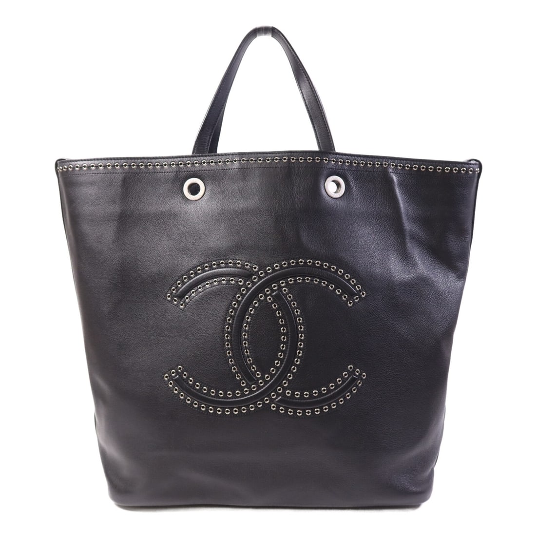 Black Calfskin Coco Eyelets Tote by CHANEL with Silver Tone Hardware: Black Calfskin Coco Eyelets Tote by CHANEL with Silver Tone Hardware This CHANEL CC Coco Eyelets tote bag is crafted from black calfskin leather and features silver-tone hardware. It has a spacious in