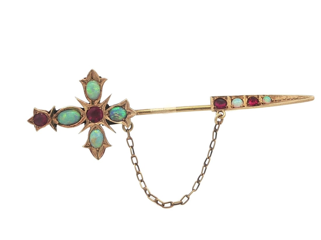 Victorian Era 15ct Yellow Gold Jabot Pin with Opal and Ruby Cross Motif: Victorian Era 15ct Yellow Gold Jabot Pin with Opal and Ruby Cross Motif This antique Victorian jabot pin brooch features a cross design set with natural old cut opals and rubies. Crafted in solid 15ct