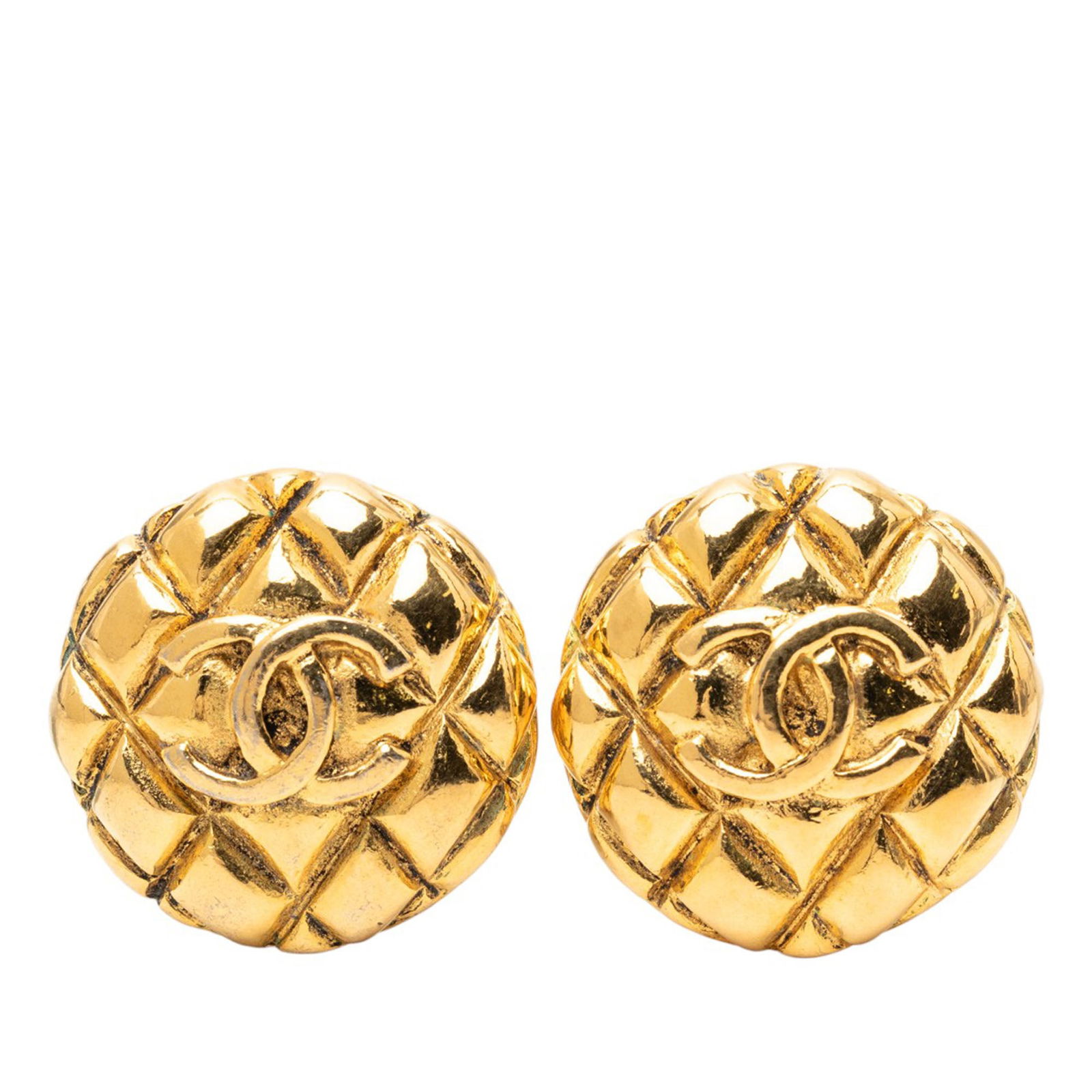 Chanel CC Quilted Round Gold Plated Clip Earrings: Chanel CC Quilted Round Gold Plated Clip Earrings These Chanel clip-on earrings feature a round, quilted design with the signature CC logo. Crafted from gold plated metal, they offer a classic and ele