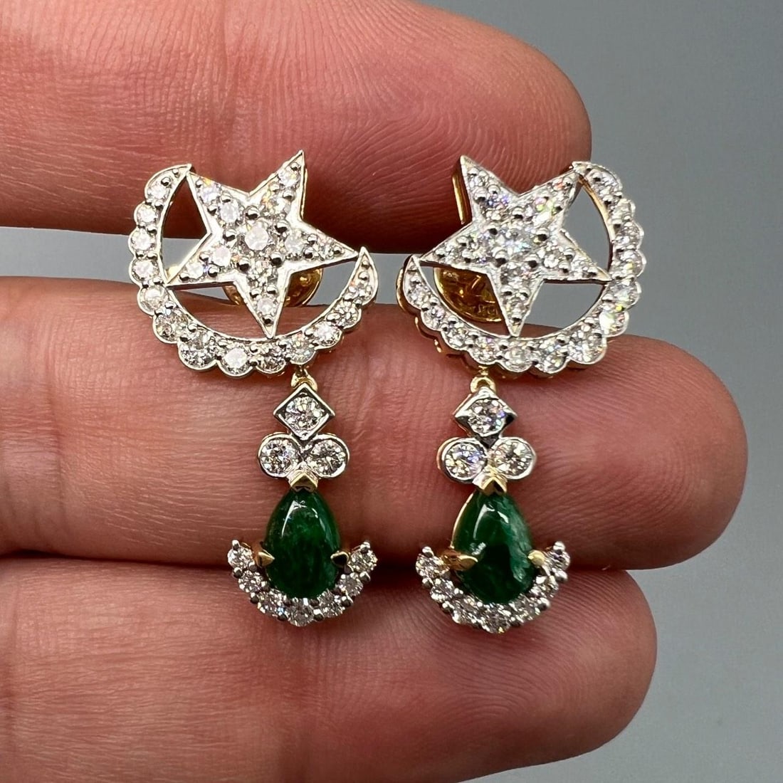 Emerald and Diamond Earrings in 18K Yellow Gold with 1.25 Inch Length: Emerald and Diamond Earrings in 18K Yellow Gold with 1.25 Inch Length Elegant earrings crafted in 18K yellow gold, featuring two emeralds with an approximate total weight of 1.20 carats. Accented by 6