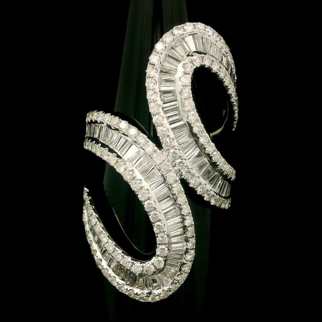 18k White Gold 3.50ctw Diamond Cocktail Wrap Ring: 18k White Gold 3.50ctw Diamond Cocktail Wrap Ring This stunning cocktail ring features a striking design crafted from solid 18k white gold, showcasing a total carat weight of approximately 3.50ct. The