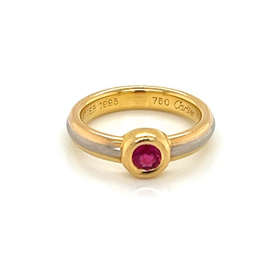 Cartier Tri Color 18k Gold Ruby Band Ring with Certificate Size 4: Cartier Tri Color 18k Gold Ruby Band Ring with Certificate Size 4 This Cartier stack band ring features 18k tri-color gold and a vibrant ruby set in a sophisticated bezel. The ring is a size 4 (US) an