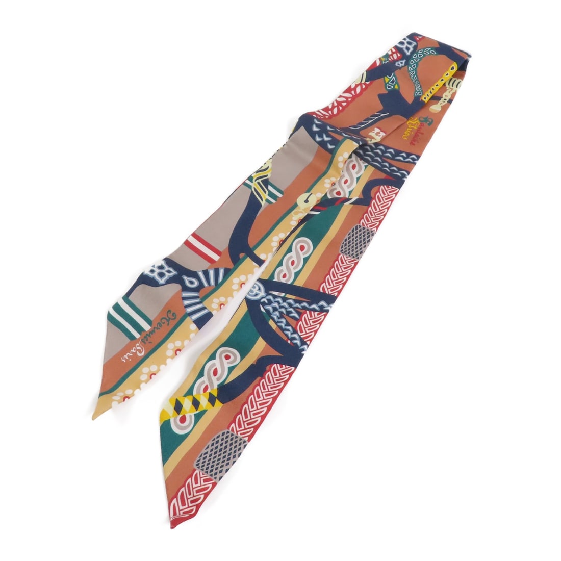 Silk Twilly Scarf by Hermes in Brown Blue Multicolor: Silk Twilly Scarf by Hermes in Brown Blue Multicolor This Hermes Twilly scarf features a multicolor design with shades of brown and blue. Crafted from silk, it offers a luxurious and stylish accessory
