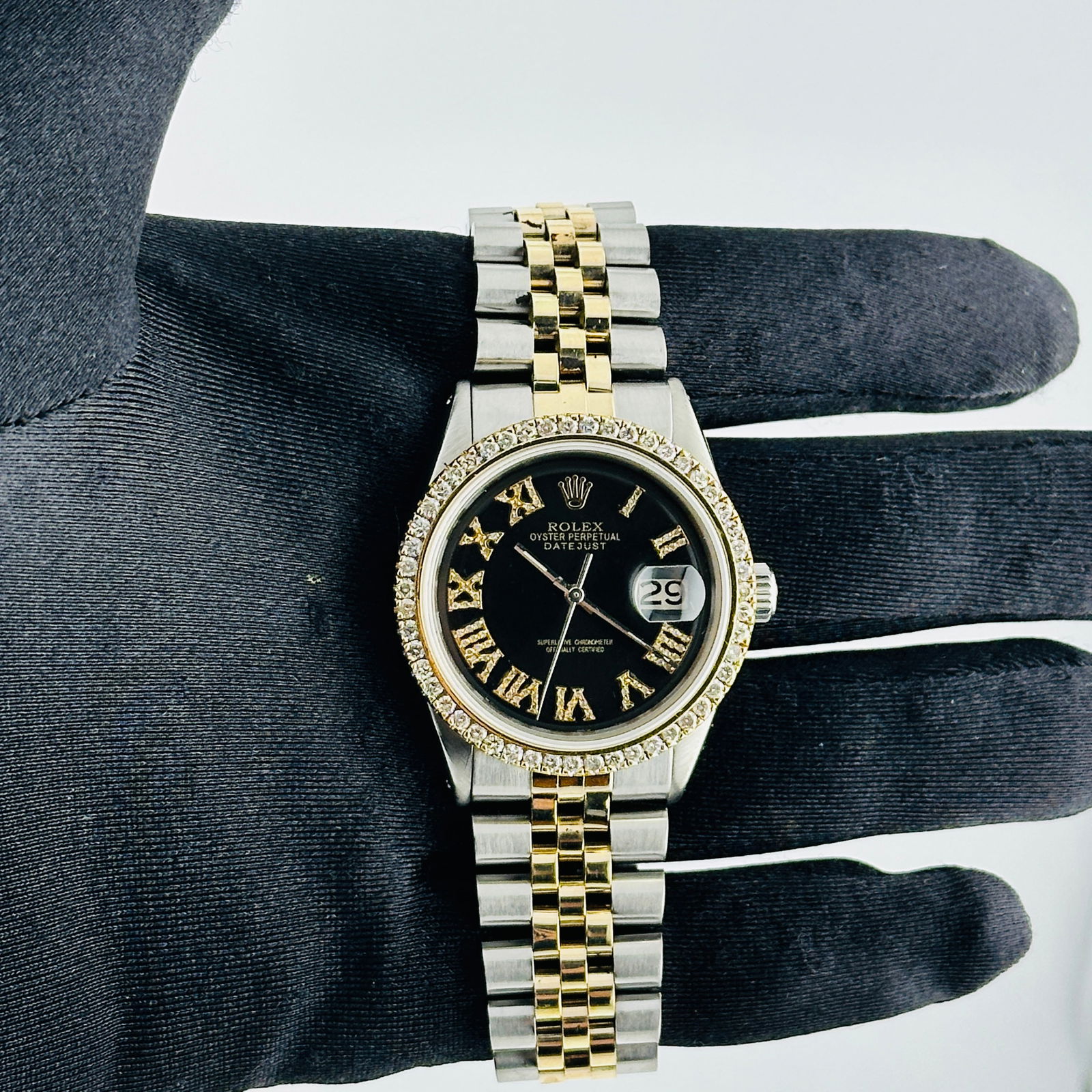 Aftermarket Black Roman Diamond Dial Jubilee Rolex Datejust Ref 1601: Aftermarket Black Roman Diamond Dial Jubilee Rolex Datejust Ref 1601 This Rolex Datejust features a custom black dial with Roman numerals and diamond accents, complemented by a prong-set diamond bezel
