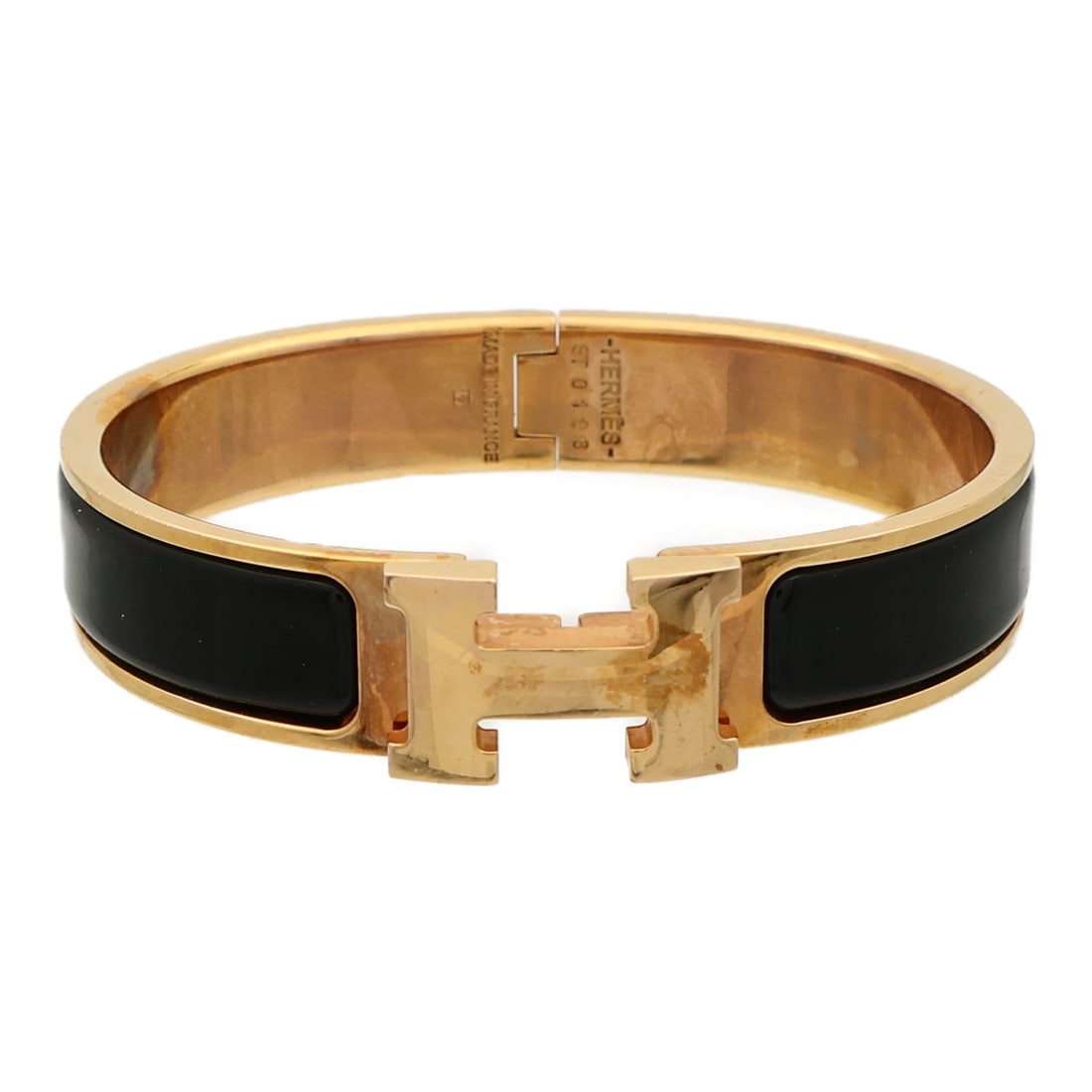 Black Enamel Hermes Clic H Bracelet with Gold Hardware: Black Enamel Hermes Clic H Bracelet with Gold Hardware This HERMES Clic H bracelet features a black enamel design with gold tone accents. Crafted in France, it is styled for a regular fit and offers a