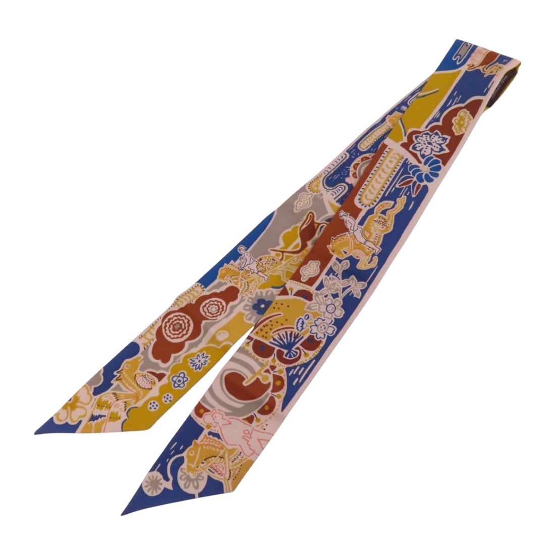 Silk Twilly Scarf by Hermes in Brown and Blue Tones: Silk Twilly Scarf by Hermes in Brown and Blue Tones This Hermes Twilly scarf is crafted from silk and features a blue, brown, and multicolor design. Made in France, it offers a stylish accessory optio