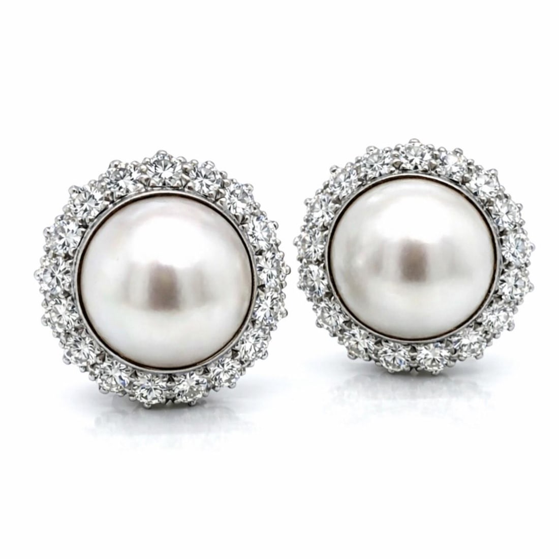 Pair of 18K White Gold Earrings with Mabe Pearls and Diamonds: Pair of 18K White Gold Earrings with Mabe Pearls and Diamonds These earrings are crafted from 18K white gold and feature two Mabe pearls, each measuring approximately 14.95mm. The design is accented w