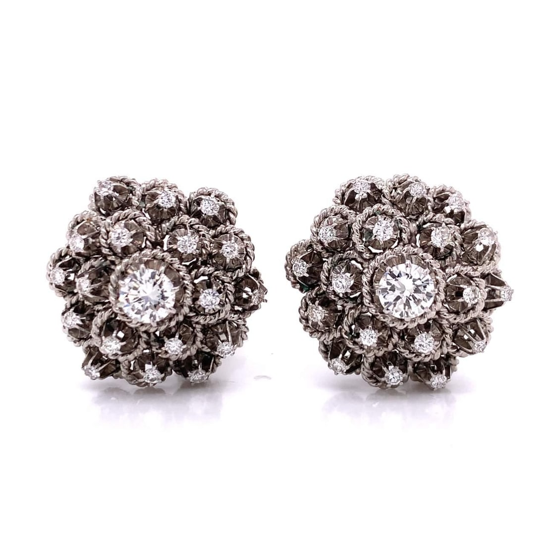 Timeless 1950's 14K White Gold Diamond Earrings 1.10 Ct Center: Timeless 1950's 14K White Gold Diamond Earrings 1.10 Ct Center These exquisite 1950's 14K white gold diamond earrings are a timeless accessory. Weighing 20.8 grams, they feature two center diamonds wi
