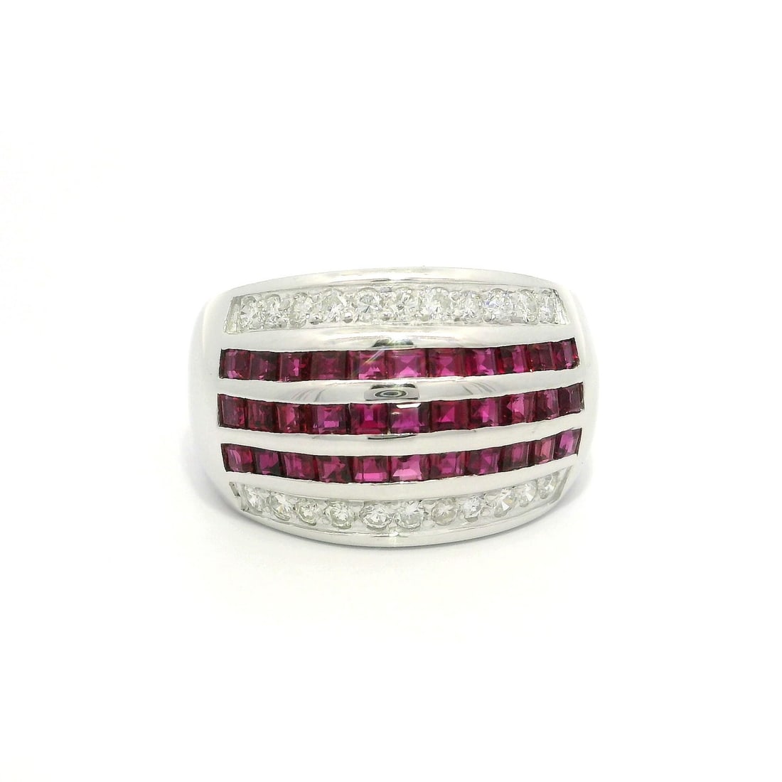 Vintage Platinum Wide Band Ring with Ruby Diamond 1.75ctw: Vintage Platinum Wide Band Ring with Ruby Diamond 1.75ctw This stunning vintage cocktail ring showcases a luxurious design featuring five rows of calibre cut rubies and diamonds. The centerpiece consi