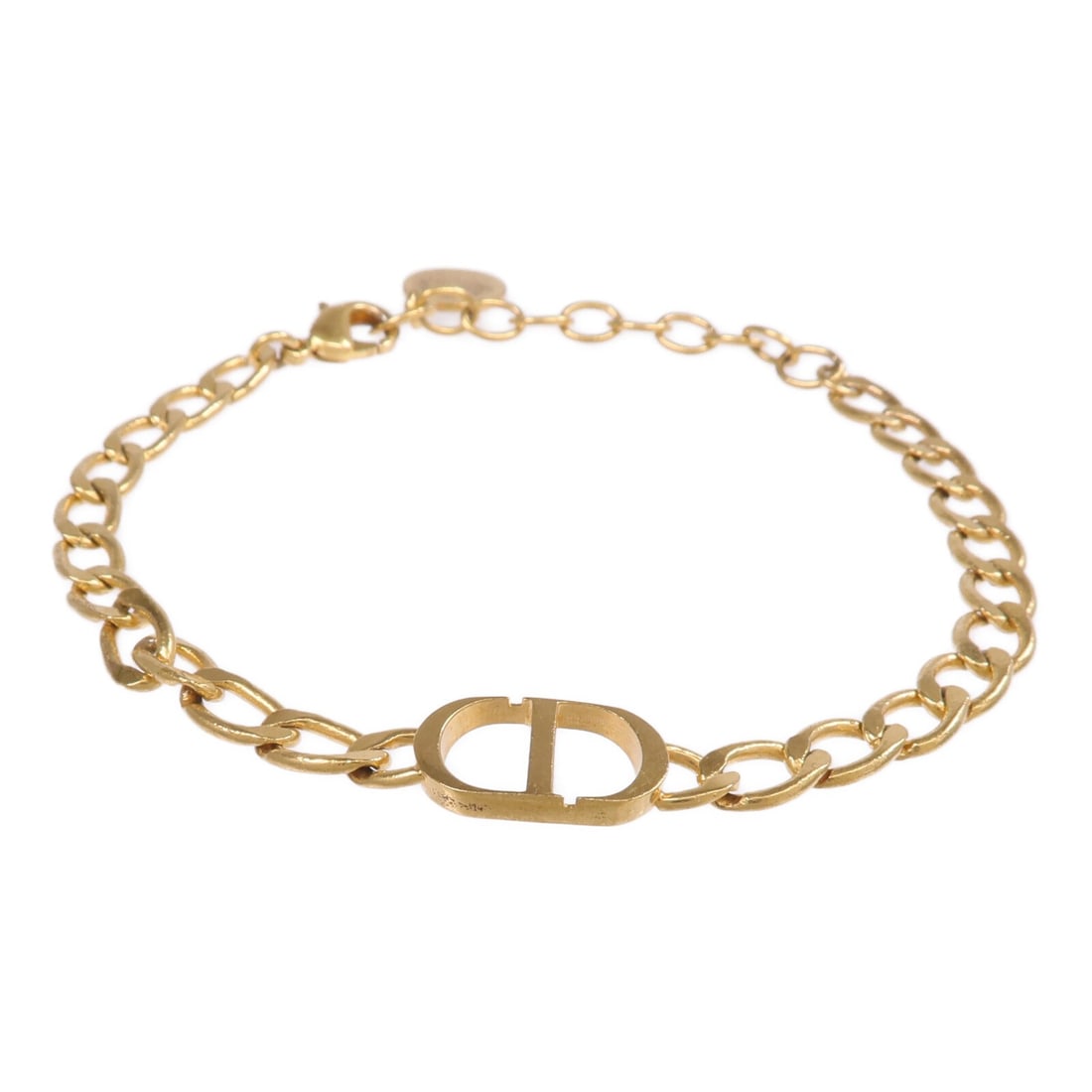 Gold Tone Metal Dior CD Logo Bracelet from France: Gold Tone Metal Dior CD Logo Bracelet from France This Christian Dior bracelet features a gold-tone finish and is crafted from non-specified metal. Designed without gemstones, it offers a sleek and