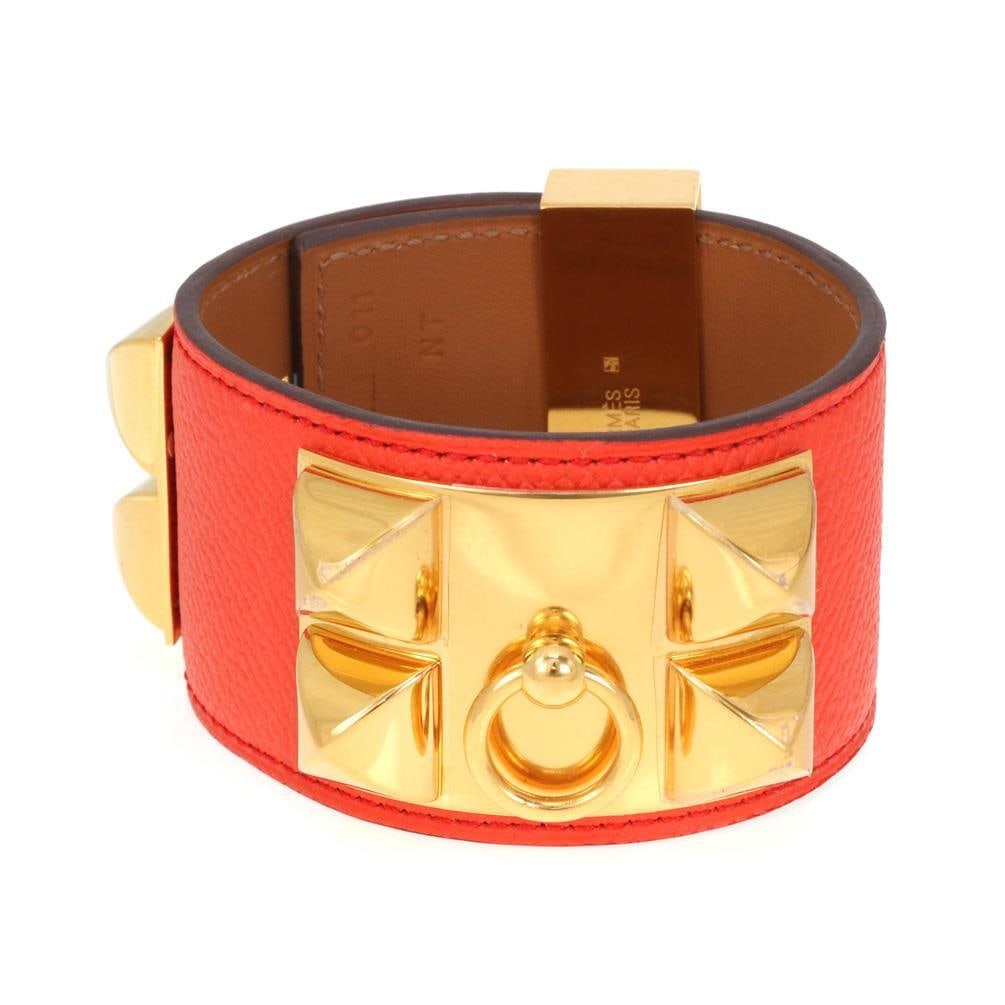 Authentic Hermes Collier De Chien Wide Cuff Bracelet Orange Leather: Authentic Hermes Collier De Chien Wide Cuff Bracelet Orange Leather Introducing the authentic Collier De Chien Wide Cuff (CDC) Bracelet from Hermes, crafted from vibrant orange leather. This striking