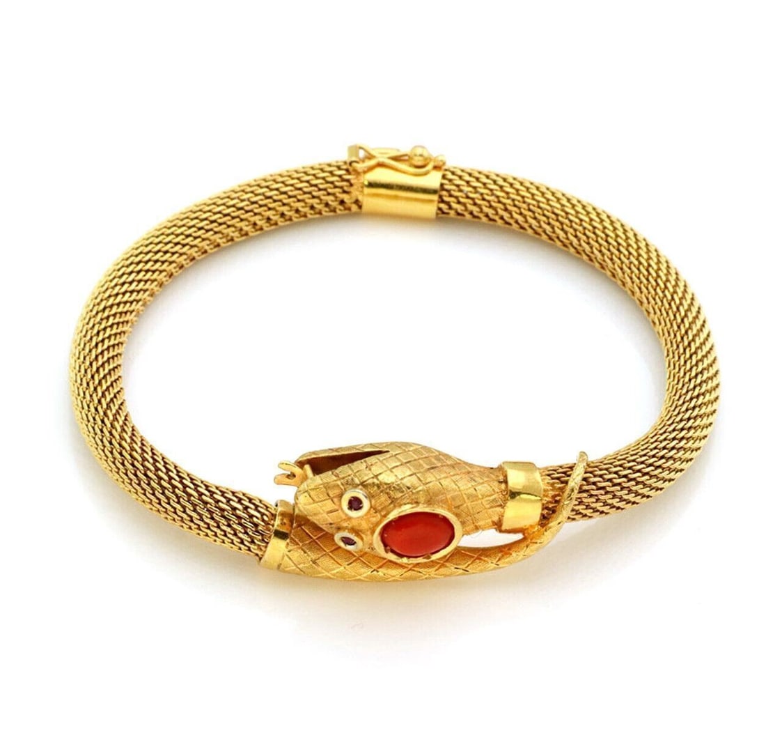 18k Yellow Gold Mesh Cuff Bracelet with Coral Snake Motif: 18k Yellow Gold Mesh Cuff Bracelet with Coral Snake Motif This vintage bangle cuff bracelet is crafted from 18k yellow gold and features a flexible mesh design inspired by a coral snake. The bracelet
