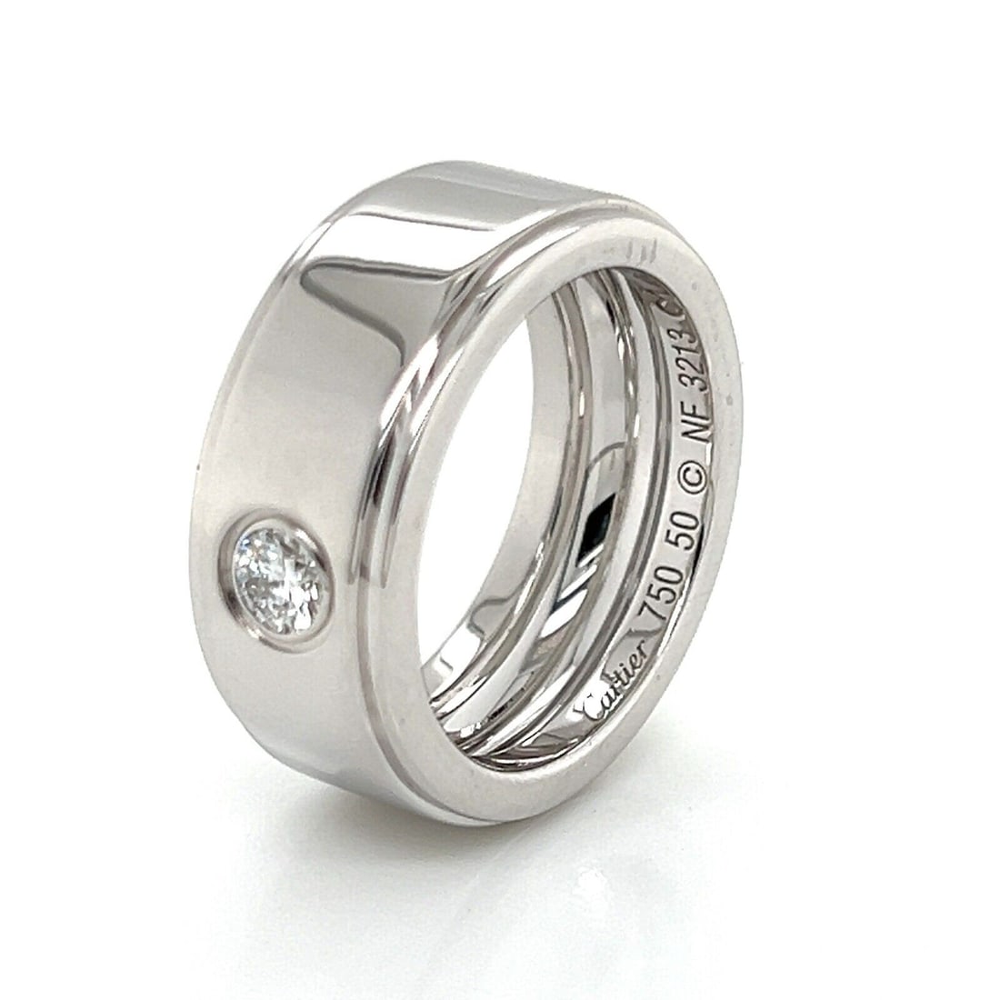 Size 5 Cartier 18k White Gold Wedding Band with Diamond Accent: Size 5 Cartier 18k White Gold Wedding Band with Diamond Accent This authentic Cartier wedding band is crafted from 18k white gold and showcases a sleek wide-band design set with a single diamond. Sign
