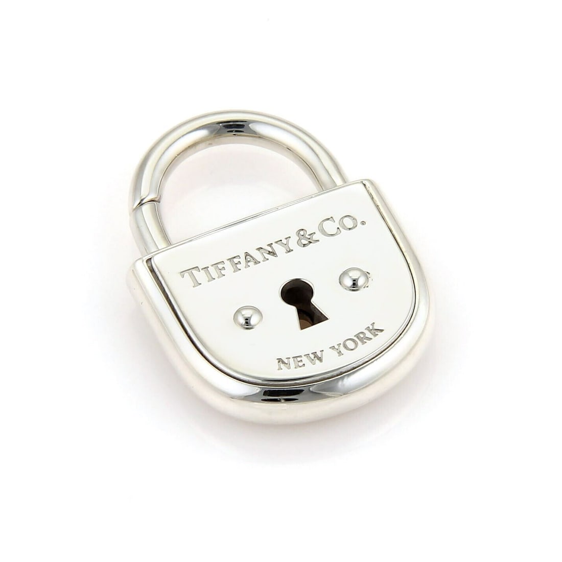 Sterling Silver Arc Padlock Pendant Charm by Tiffany & Co.: Sterling Silver Arc Padlock Pendant Charm by Tiffany & Co. This Tiffany & Co. Arc Pad Lock charm pendant is crafted from solid sterling silver and features a padlock design. It can be worn as a pendan