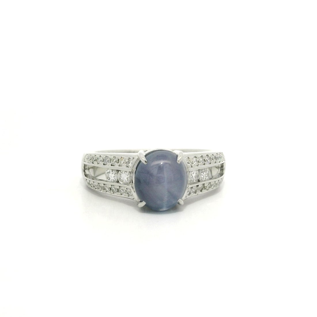 Platinum 3.19ctw Star Sapphire Ring with Diamonds: Platinum 3.19ctw Star Sapphire Ring with Diamonds This exquisite ring features a solid platinum band, showcasing a striking natural star sapphire at its center. The sapphire is an oval cabochon cut, m