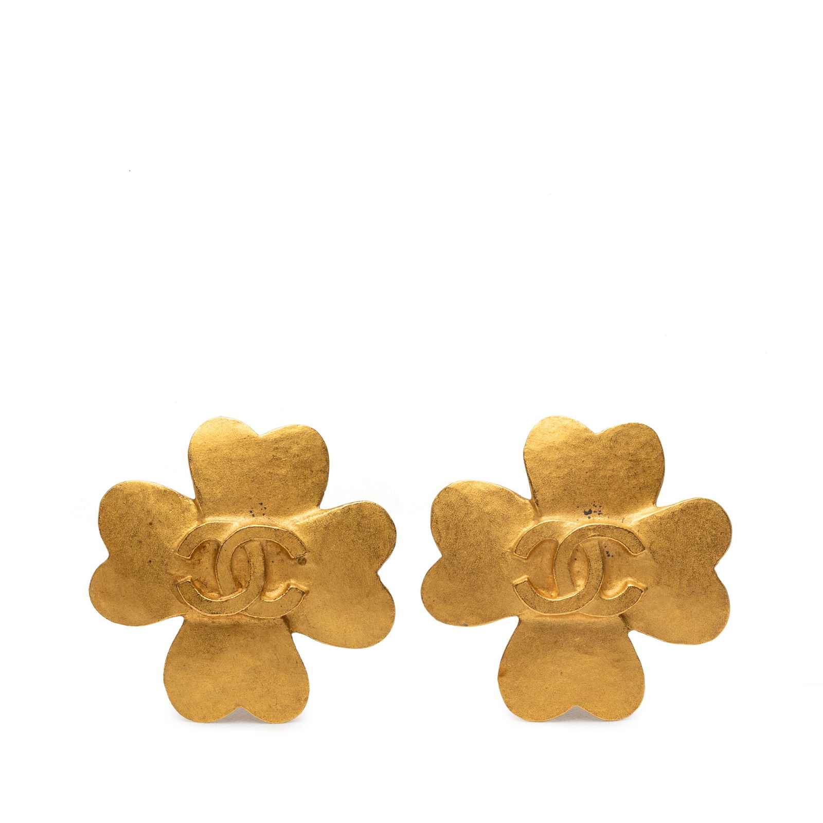 Chanel Clover Motif Gold Plated Clip On Earrings: Chanel Clover Motif Gold Plated Clip On Earrings These Chanel clip-on earrings feature a gold plated metal body with an elegant clover design and CC logo. Made in France, they offer a sophisticated co