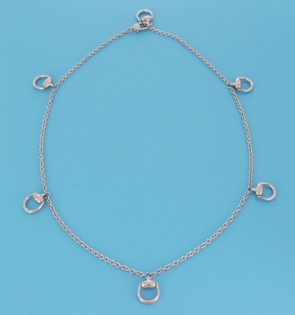 Gucci 18k White Gold Necklace with Six Horsebit Motifs 16.5 Inch: Gucci 18k White Gold Necklace with Six Horsebit Motifs 16.5 Inch This Gucci necklace is crafted from solid 18k white gold and features six polished horsebit motifs spaced along a refined chain. The el