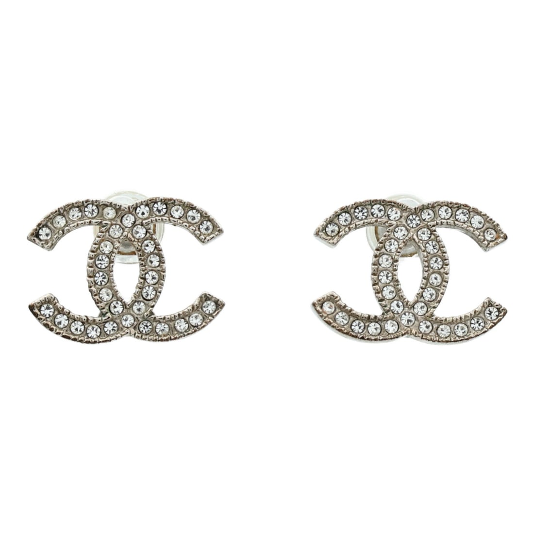 Silver Tone Pierced Earrings from CHANEL with CC Logo: Silver Tone Pierced Earrings from CHANEL with CC Logo These CHANEL CC pierced earrings feature a silver-tone finish and are crafted from metal. The design showcases the iconic CC logo. They do not inc