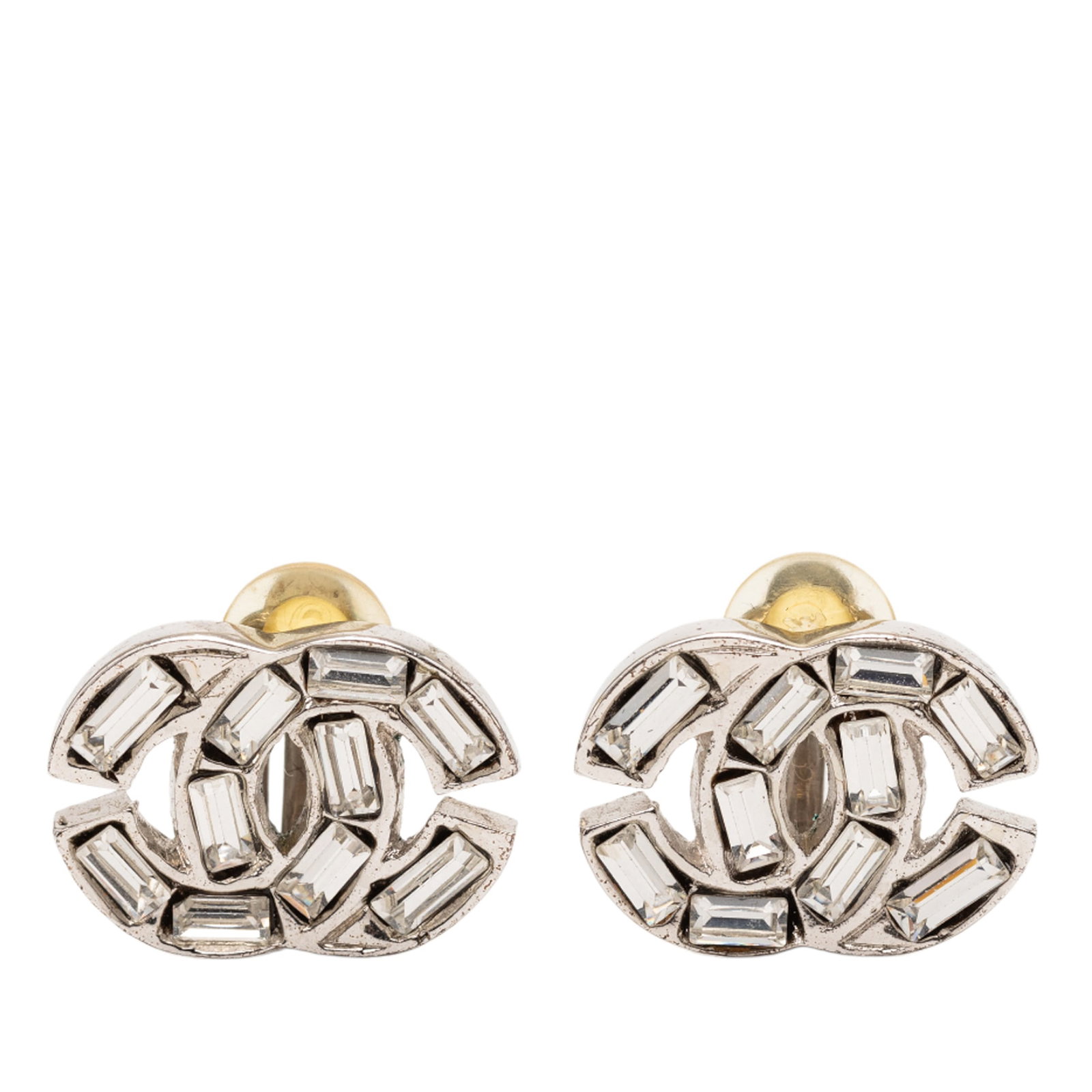 Chanel Rhinestone Silver Plated Clip-On CC Earrings: Chanel Rhinestone Silver Plated Clip-On CC Earrings These Chanel earrings feature a silver-plated metal body adorned with rhinestone embellishments and secure clip-on closures. The earrings are catego