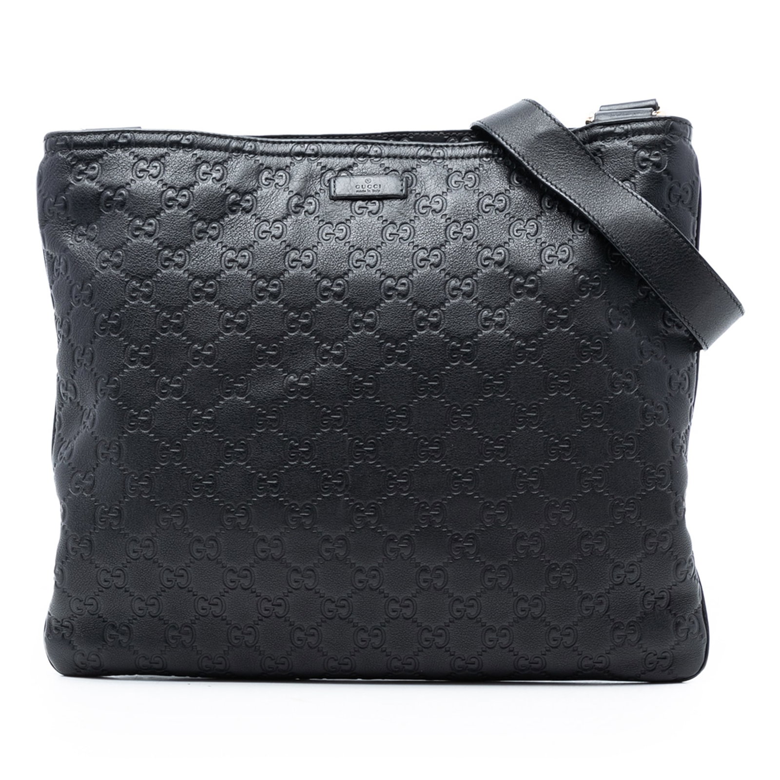 Black Leather Gucci Guccissima Adjustable Crossbody Bag with Zip Closure: Black Leather Gucci Guccissima Adjustable Crossbody Bag with Zip Closure This black crossbody bag features an embossed leather exterior, an adjustable flat leather strap, a top zip closure, and an int