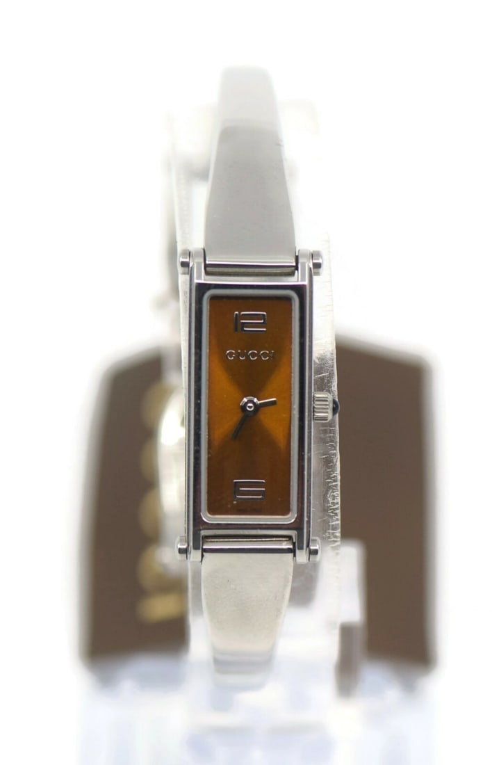 Gucci YA015529 Stainless Steel Bangle Wristwatch 12mm Authentic: Gucci YA015529 Stainless Steel Bangle Wristwatch 12mm Authentic This elegant Gucci bangle wristwatch features a sleek stainless steel design, combining modern aesthetics with timeless luxury. The watc