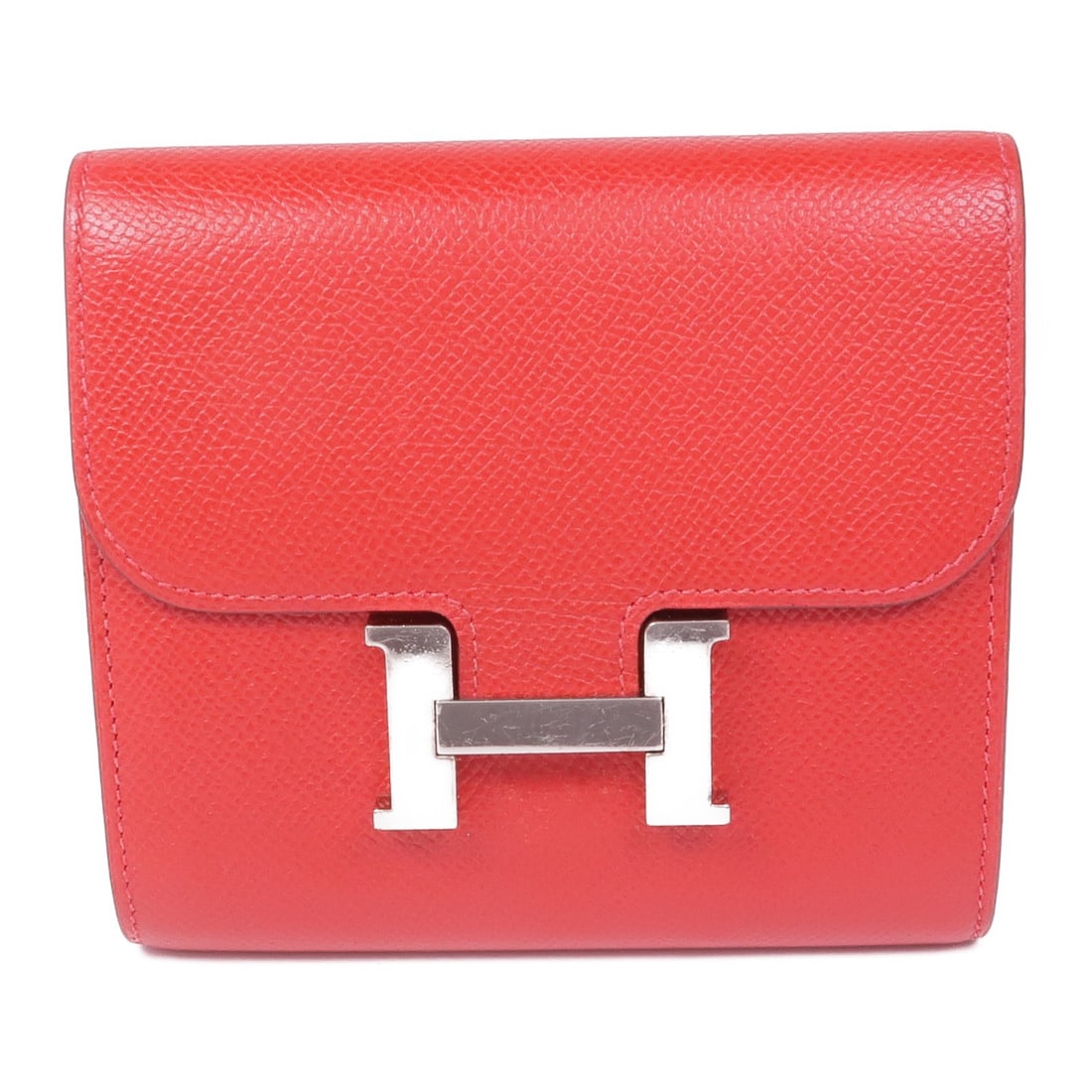 HERMES Constance Bi-Fold Wallet Epsom Leather Red: HERMES Constance Bi-Fold Wallet Epsom Leather Red This elegant HERMES Constance Wallet is crafted from high-quality Epsom leather, showcasing a striking red hue. Designed as a bi-fold wallet, it offer
