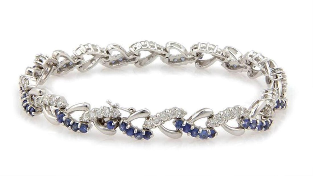 Heart Link Chain Bracelet with Diamonds and Sapphires in 18k White Gold: Heart Link Chain Bracelet with Diamonds and Sapphires in 18k White Gold This vintage bracelet is crafted from 18k white gold and features an elegant chain design with heart-shaped links. Set with 1.20