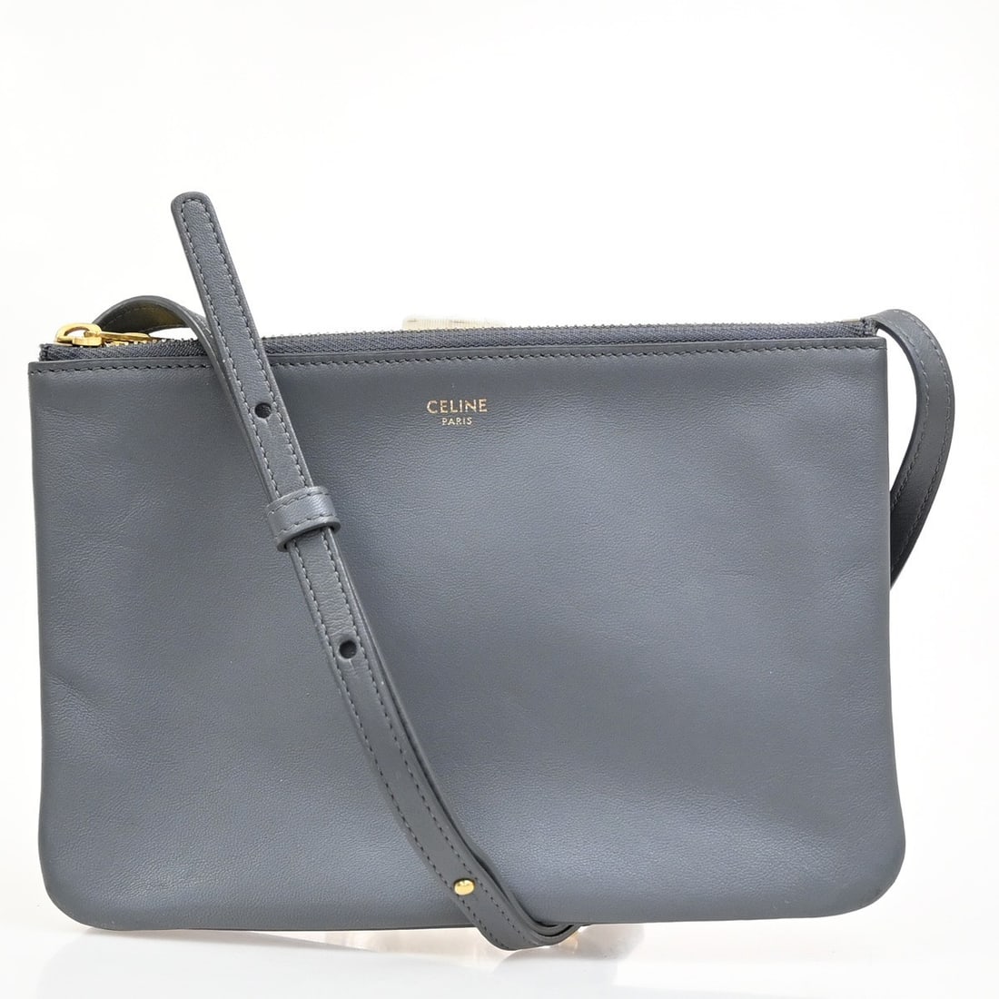 Celine Gray Leather Trio Crossbody Purse for Women: Celine Gray Leather Trio Crossbody Purse for Women This Celine Trio Crossbody Bag is crafted from leather in a gray color, designed for female use. It features a compact and versatile design suitable