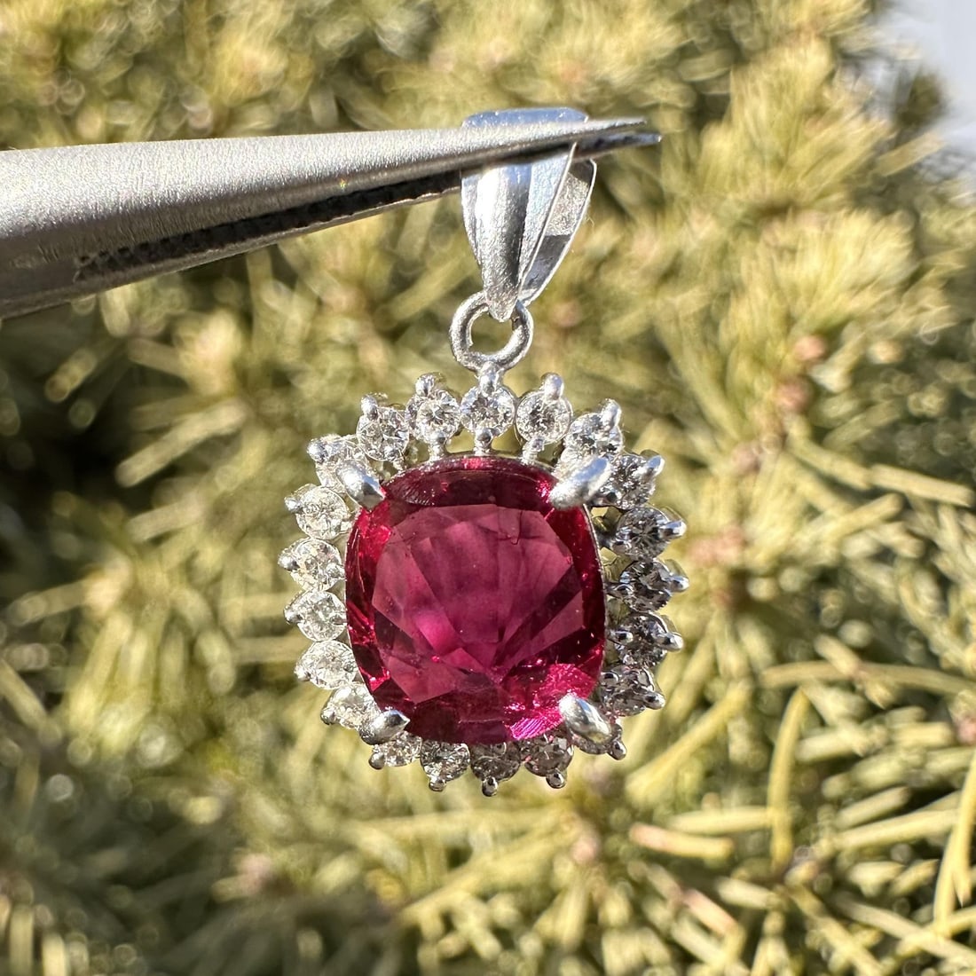 GIA Certified Platinum Pendant With Natural No Heat Cushion Ruby and Diamond Halo: GIA Certified Platinum Pendant With Natural No Heat Cushion Ruby and Diamond Halo This platinum pendant features a natural, cushion-cut ruby from Thailand with no indications of heat treatment, weighi