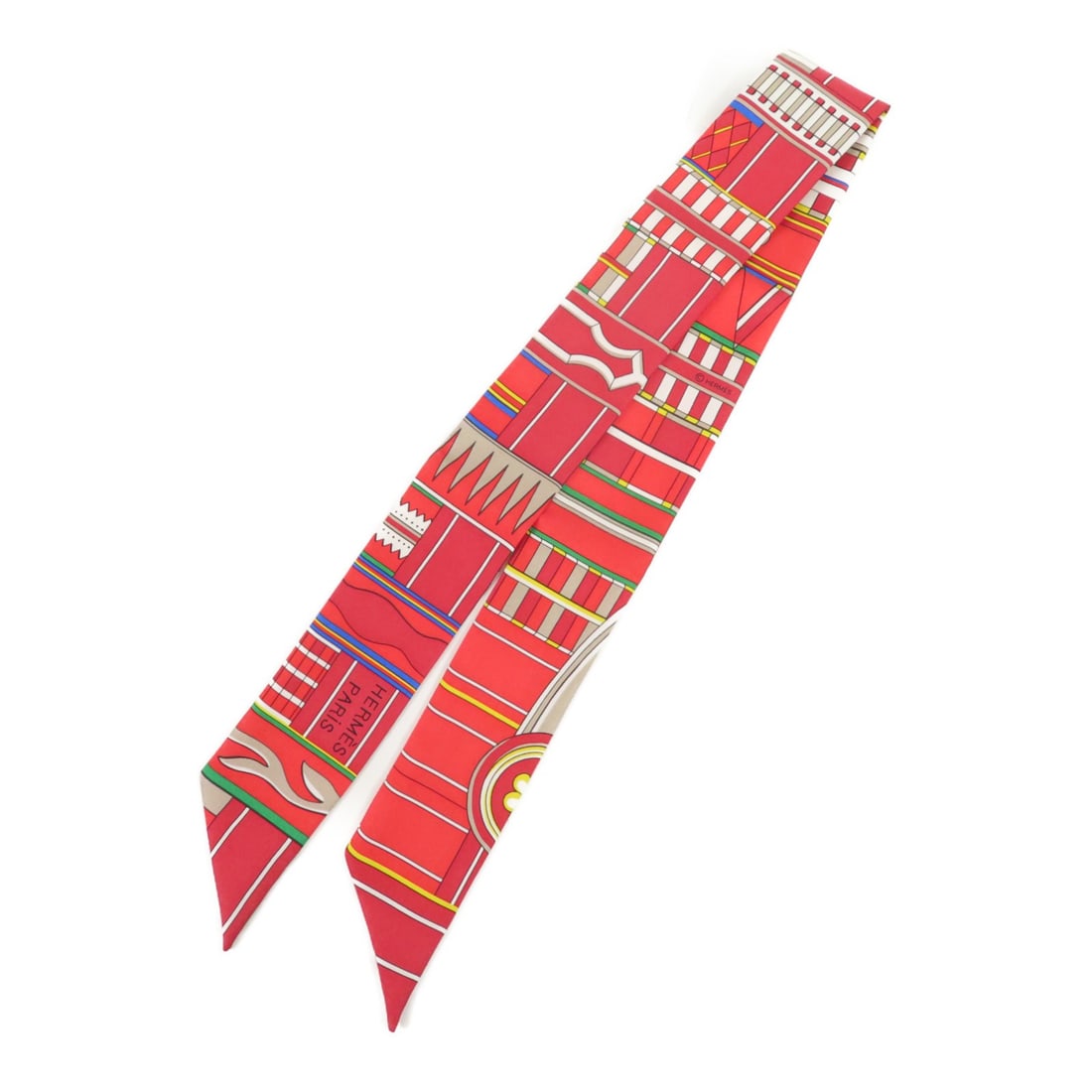 HERMES Silk Twilly Scarf in Red: HERMES Silk Twilly Scarf in Red This stunning HERMES Twilly Scarf showcases a vibrant red color, crafted from luxurious silk, making it a perfect accessory for adding a pop of color to any outfit. Des