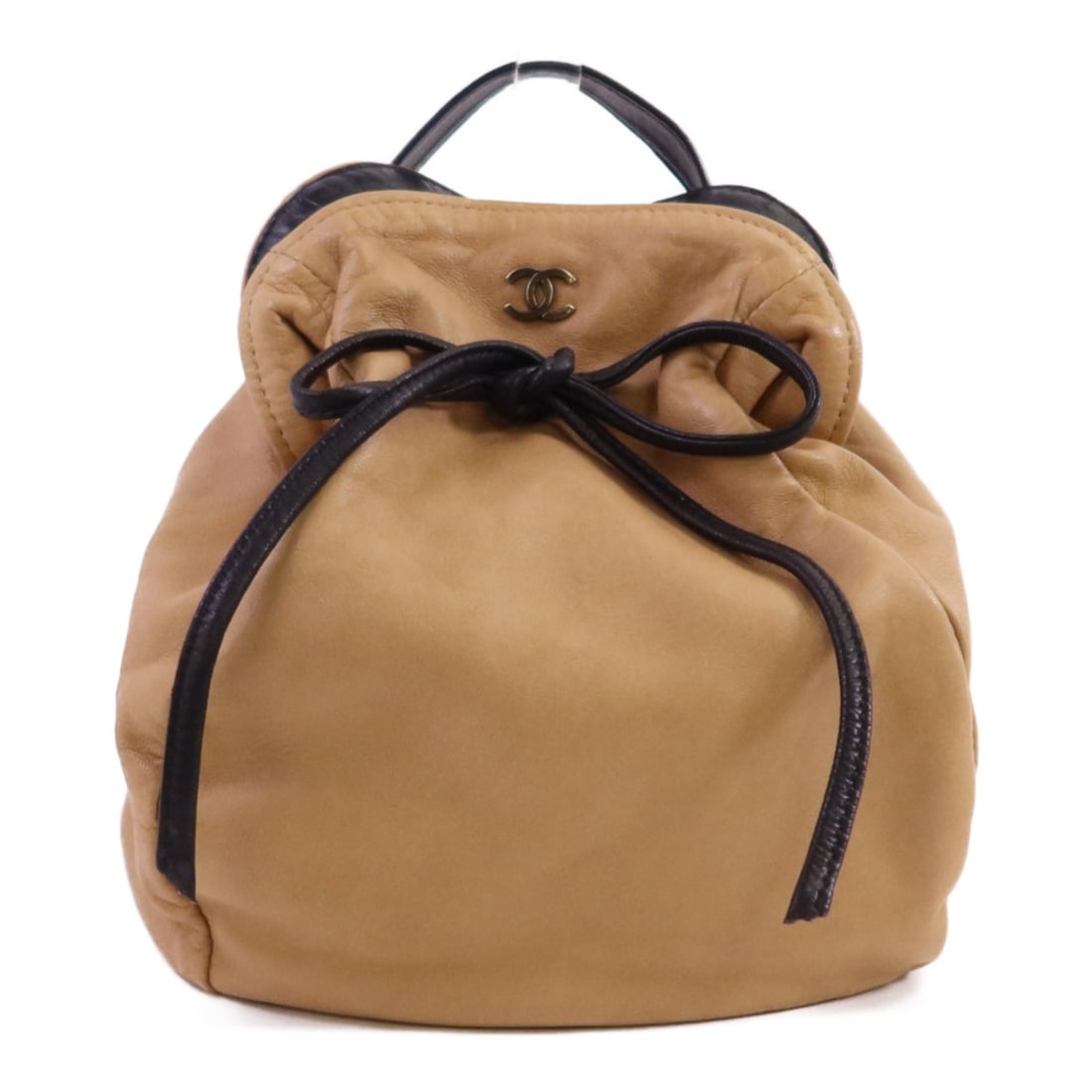 Beige Lambskin Leather CHANEL CC Logo Handbag: Beige Lambskin Leather CHANEL CC Logo Handbag This CHANEL handbag is crafted from beige lambskin leather and features a classic design. Made in France, it offers a regular size with a structured silho