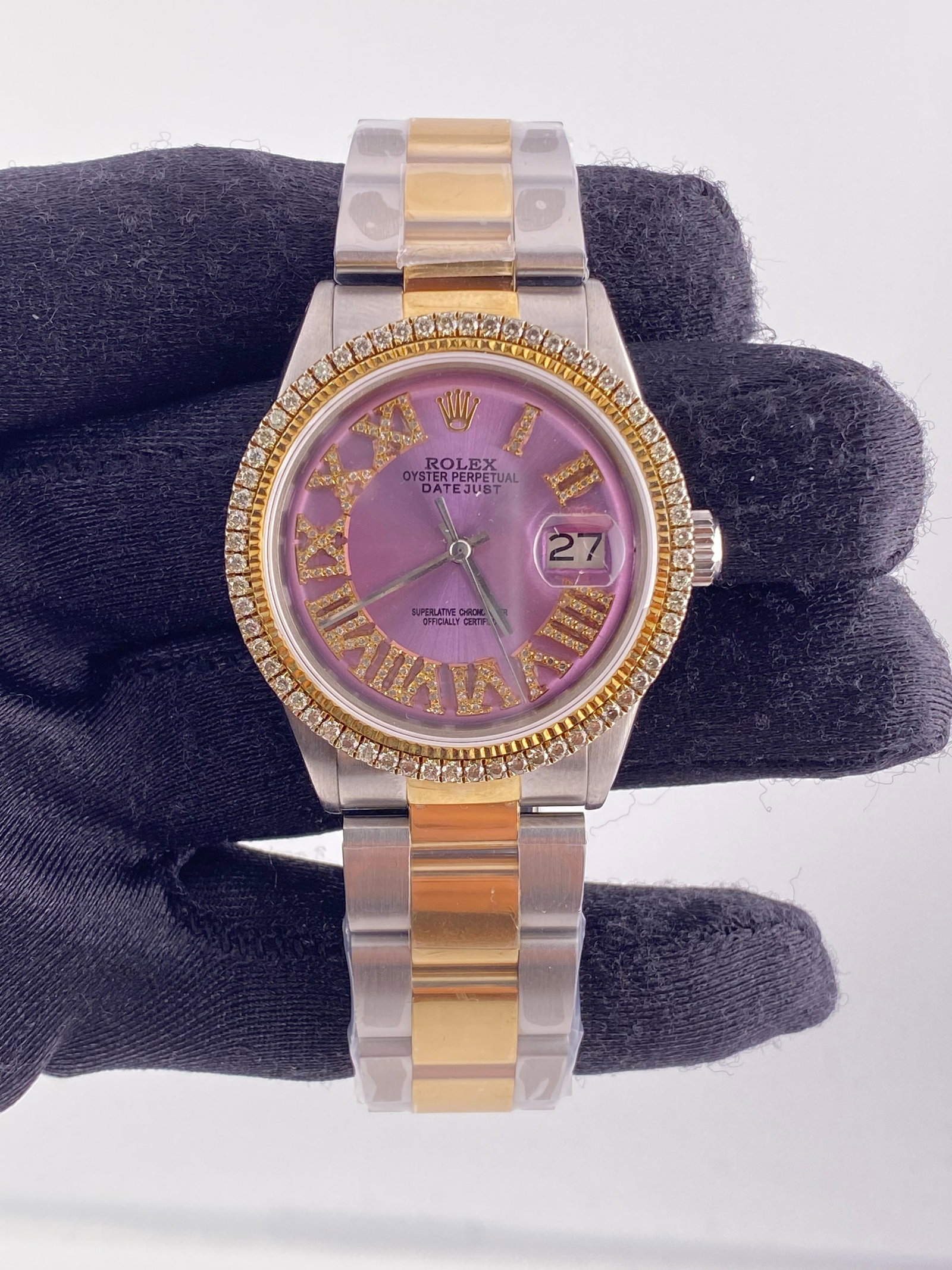 Purple Roman Dial Datejust Ref 1601 with Aftermarket Jubilee Bracelet: Purple Roman Dial Datejust Ref 1601 with Aftermarket Jubilee Bracelet This Rolex Datejust features an aftermarket purple Roman dial and an aftermarket Jubilee bracelet. The watch is equipped with a di
