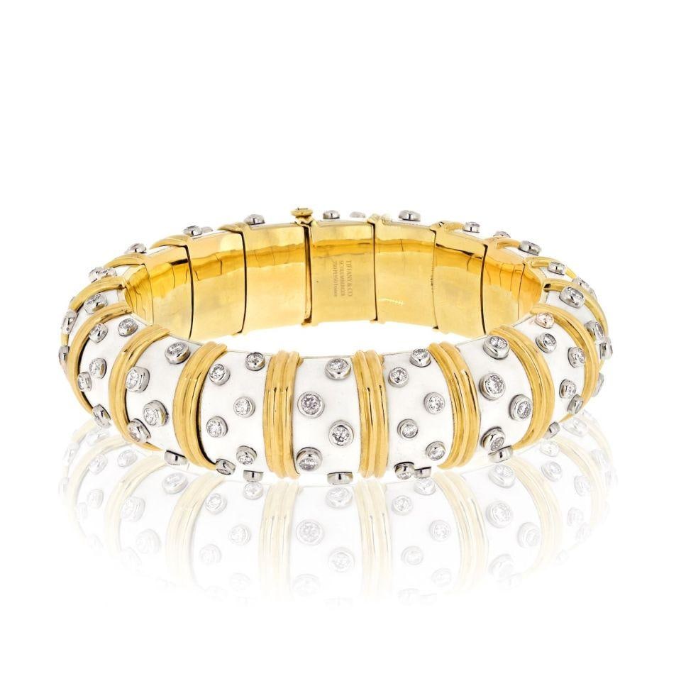 Tiffany & Co. Schlumberger 18K Gold Diamond Enamel Bangle Bracelet: Tiffany & Co. Schlumberger 18K Gold Diamond Enamel Bangle Bracelet Discover the elegance of the Tiffany & Co. Schlumberger Platinum & 18K Yellow Gold White Enamel Diamond Bangle Bracelet. This exquisi