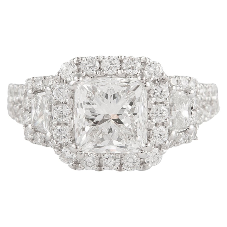 GIA Certified 2.00ct Princess Cut Three Stone Ring in 18k White Gold: GIA Certified 2.00ct Princess Cut Three Stone Ring in 18k White Gold This exquisite three-stone engagement ring features a stunning 2.00 carat GIA certified princess cut diamond, surrounded by two tra