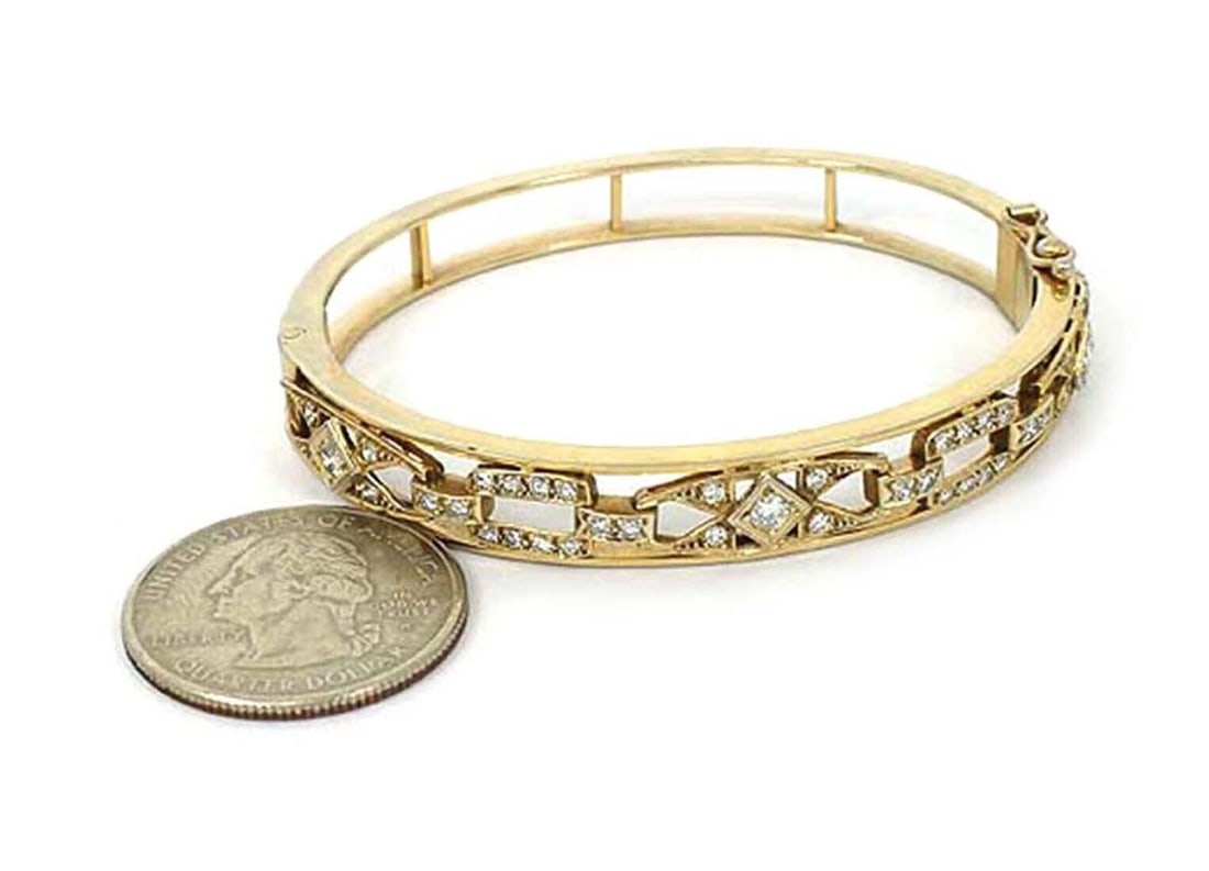Estate 14k Yellow Gold Bangle Bracelet with Openwork and 0.75ct Diamonds: Estate 14k Yellow Gold Bangle Bracelet with Openwork and 0.75ct Diamonds This vintage bangle bracelet is crafted from 14k yellow gold and features an openwork design that encircles the entire band. Th