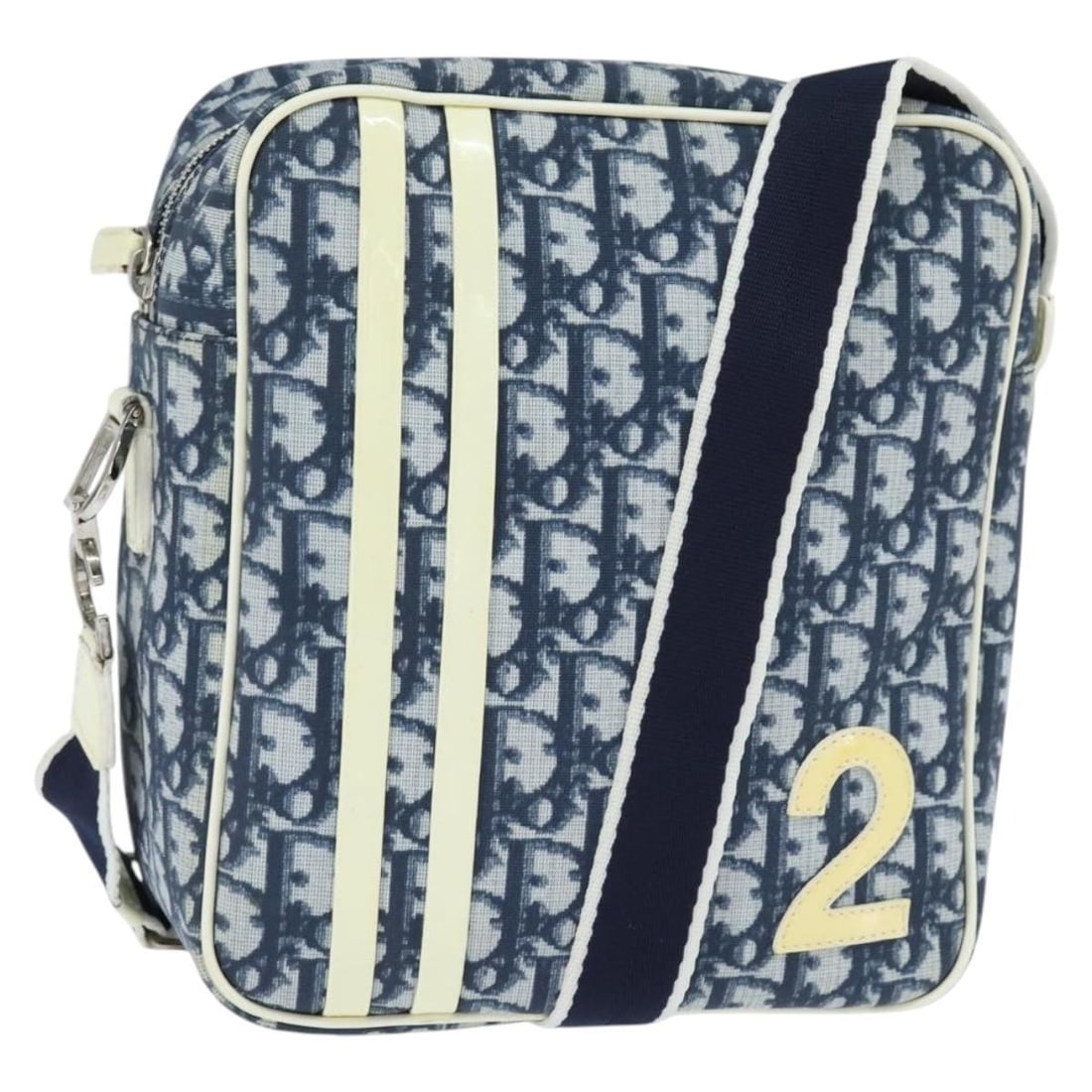 Christian Dior Blue Canvas Trotter Shoulder Bag 19cm by 21cm: Christian Dior Blue Canvas Trotter Shoulder Bag 19cm by 21cm This pre-owned Christian Dior Trotter shoulder bag for women features a blue canvas exterior with leather accents. It has a compact design