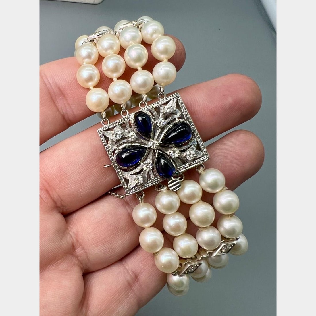 1950s 14K White Gold Bracelet with Cultured Pearls Diamonds and Synthetic Sapphires: 1950s 14K White Gold Bracelet with Cultured Pearls Diamonds and Synthetic Sapphires This 1950s bracelet is crafted in 14K white gold and features cultured pearls, diamonds, and synthetic sapphires. Th