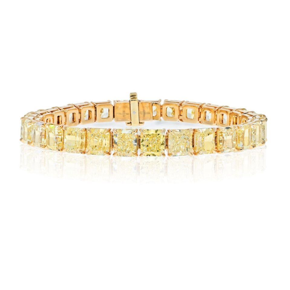 18K Yellow Gold Tennis Bracelet 29 Fancy Yellow Diamonds 32.17 Cts: 18K Yellow Gold Tennis Bracelet 29 Fancy Yellow Diamonds 32.17 Cts This exquisite tennis bracelet is handcrafted from 18K yellow gold and features a stunning array of 29 radiant cut diamonds. Each dia