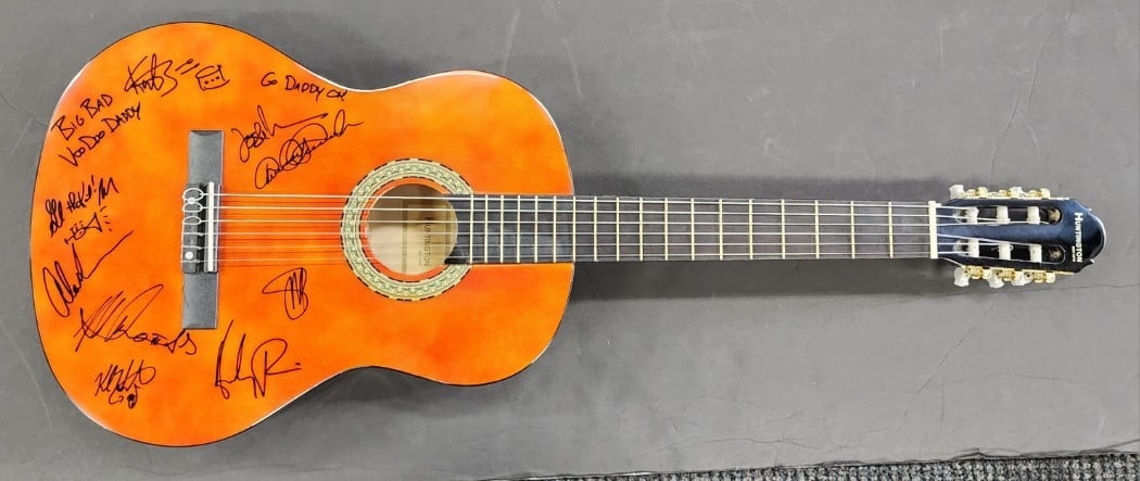 Big Bad Voodoo Daddy Signed Acoustic Guitar with 9 Signatures JSA Authenticated: Big Bad Voodoo Daddy Signed Acoustic Guitar with 9 Signatures JSA Authenticated This pre-owned acoustic guitar is a remarkable collectible signed by the entire Big Bad Voodoo Daddy band, featuring nin