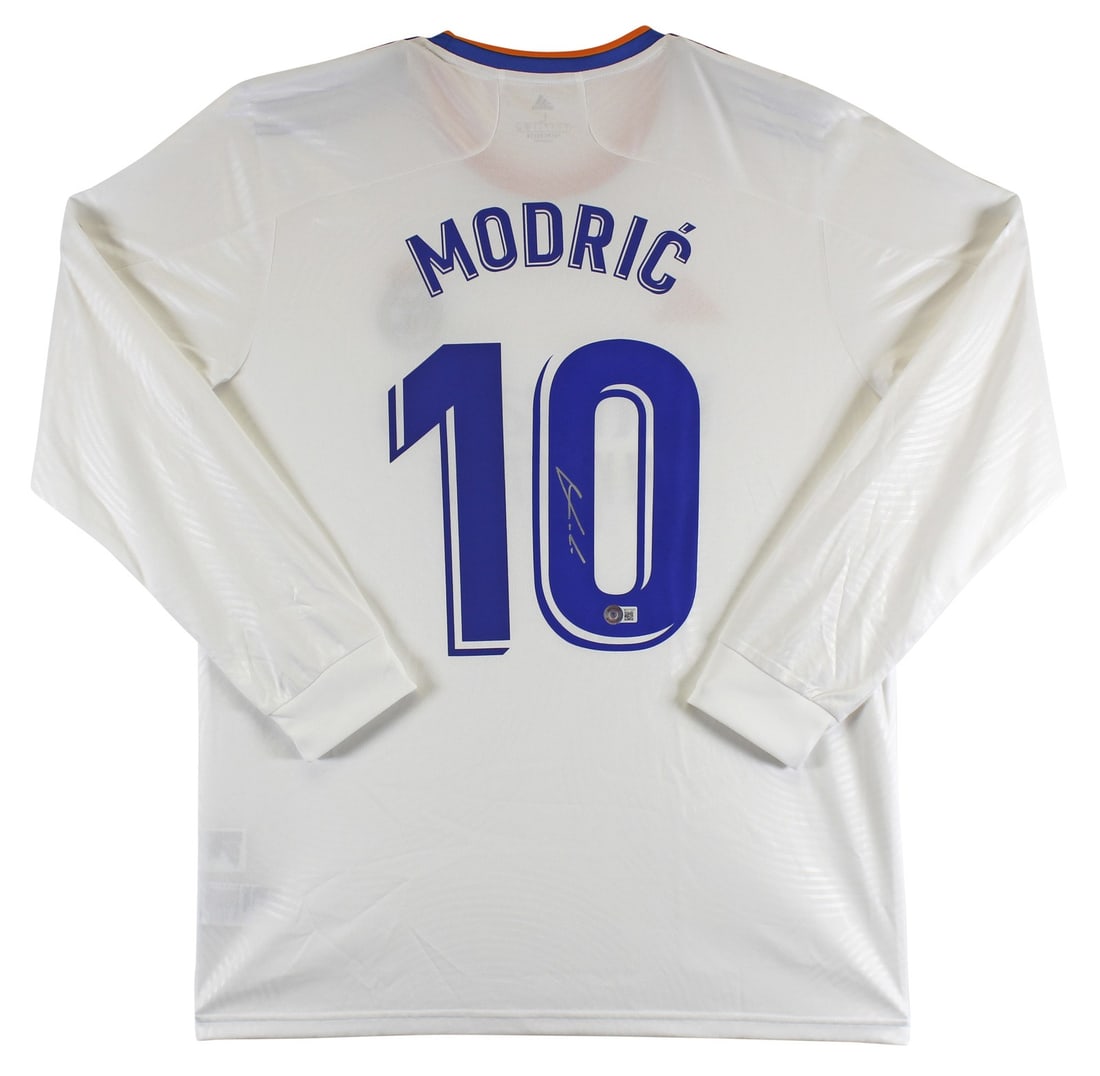 Luka Modric Signed Real Madrid White Adidas Jersey COA Beckett: Luka Modric Signed Real Madrid White Adidas Jersey COA Beckett This authentic white Adidas jersey has been personally signed by Luka Modric, a prominent player of the Real Madrid Football Club. The je