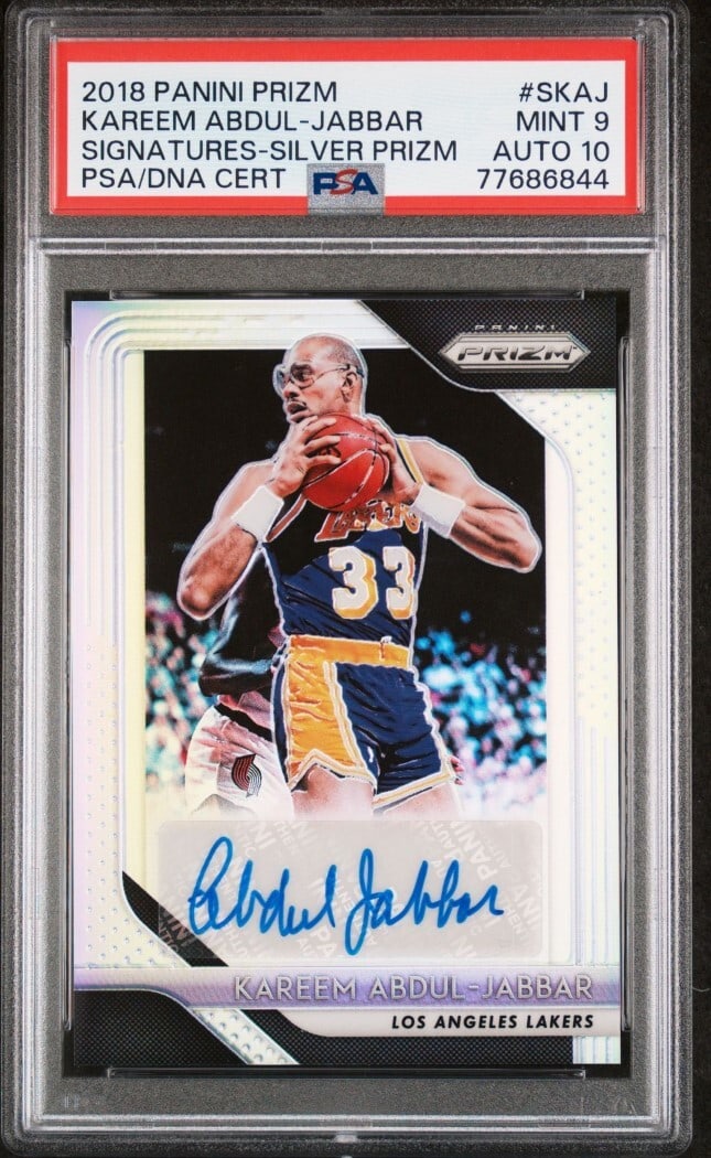 Kareem Abdul Jabbar 2018 Prizm Signatures Silver PSA 9 Lakers Card: Kareem Abdul Jabbar 2018 Prizm Signatures Silver PSA 9 Lakers Card This 2018 Prizm Signatures Silver basketball card features the legendary Kareem Abdul Jabbar. Graded by Professional Sports Authentic