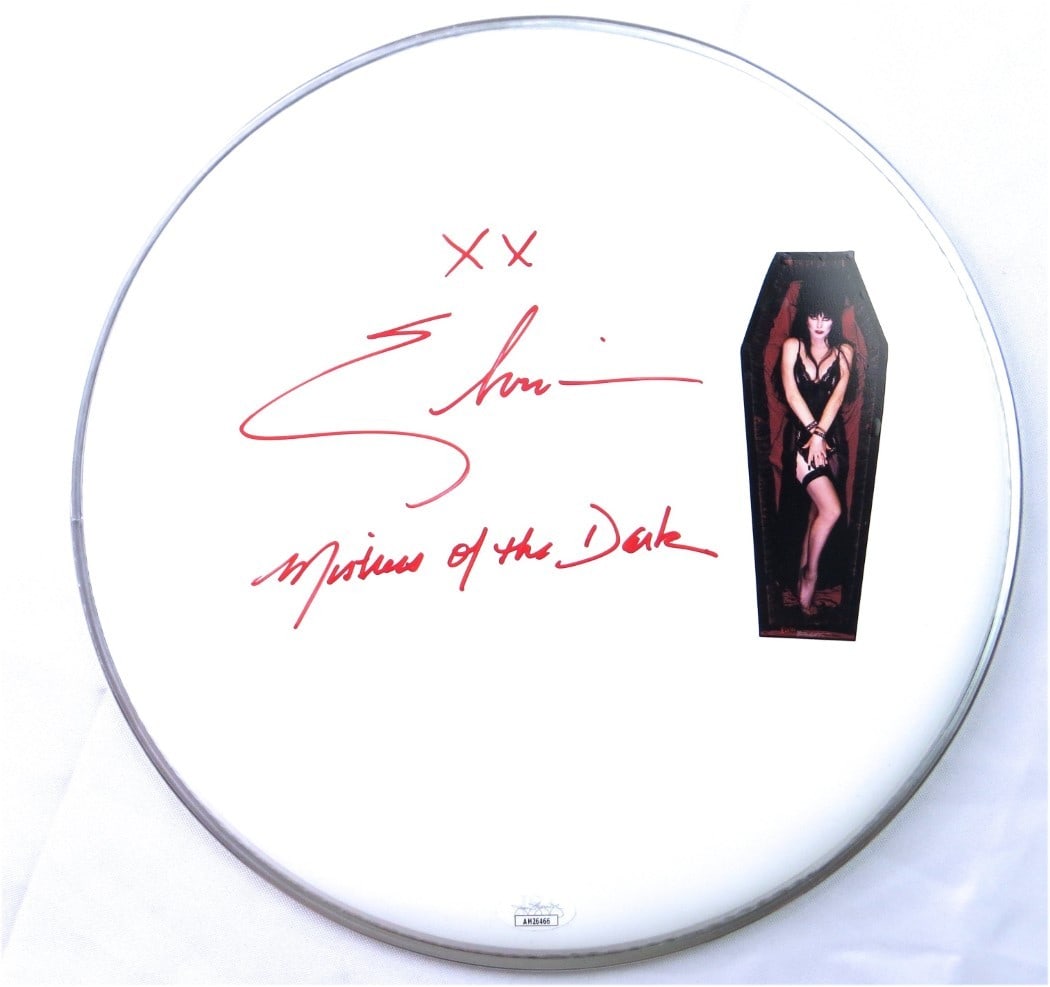 Elvira Autographed 12 Inch Drumhead With Mistress of the Dark Inscription JSA Authenticated: Elvira Autographed 12 Inch Drumhead With Mistress of the Dark Inscription JSA Authenticated This 12-inch drumhead is personally signed by Elvira, Mistress of the Dark. The autograph is authenticated b