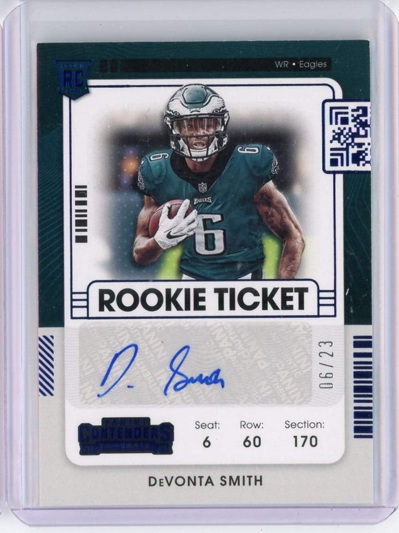 2021 Panini Contenders Devonta Smith Blue Rookie Ticket 6/23 Autographed NFL Card: 2021 Panini Contenders Devonta Smith Blue Rookie Ticket 6/23 Autographed NFL Card This is a 2021 Panini Contenders Blue Rookie Ticket card featuring Devonta Smith, numbered 6/23. The card is an origin