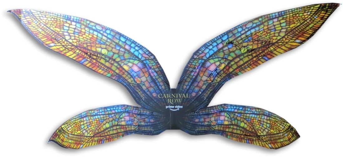 Carnival Row Cast Signed Promo Wings by Bloom Delevingne JSA Authenticated: Carnival Row Cast Signed Promo Wings by Bloom Delevingne JSA Authenticated This unique promotional item features a set of autographed wings from the cast of the acclaimed series "Carnival Row." Signed