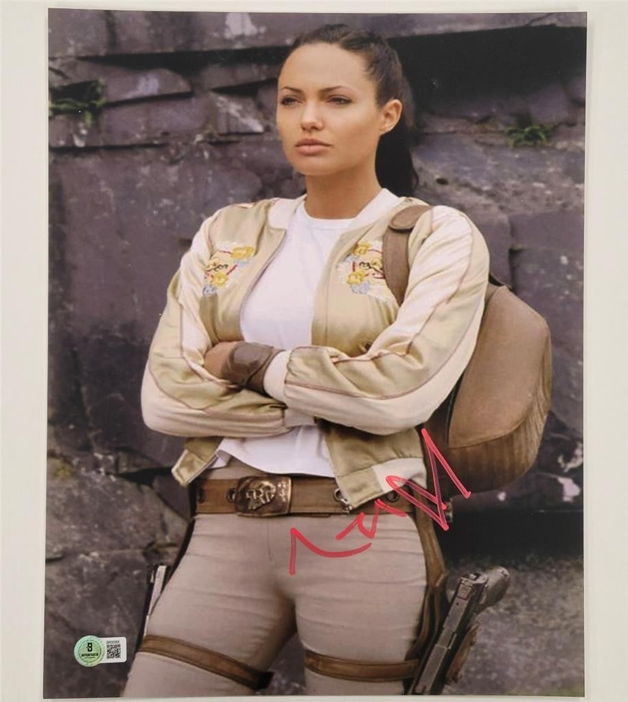 11x14 Photograph Signed by Angelina Jolie as Lara Croft Beckett Authenticated: 11x14 Photograph Signed by Angelina Jolie as Lara Croft Beckett Authenticated This is an original 11x14 photograph signed by Angelina Jolie, known for her role as Lara Croft. The autograph has been au