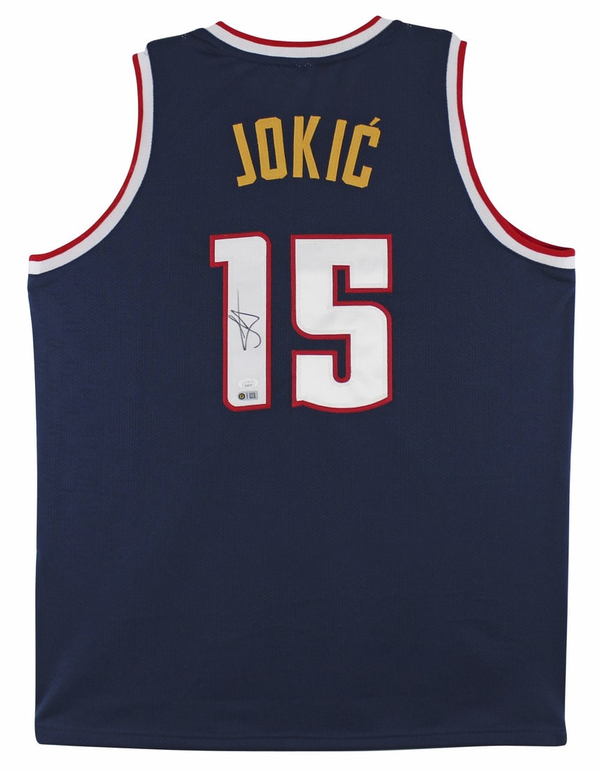 Nikola Jokic Signed Denver Nuggets Jersey with JSA COA: Nikola Jokic Signed Denver Nuggets Jersey with JSA COA This authentic autographed navy blue pro style jersey features the signature of Nikola Jokic, star player of the Denver Nuggets. The jersey is cu