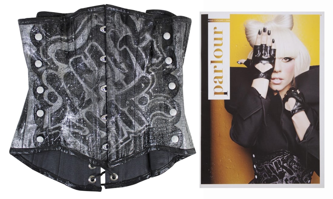 Lady Gaga Worn Faux Snake Skin Corset with Graffiti Style Art: Lady Gaga Worn Faux Snake Skin Corset with Graffiti Style Art This striking faux snakeskin corset features a unique black and silver design enhanced with graffiti-style art, famously worn by Lady Gaga