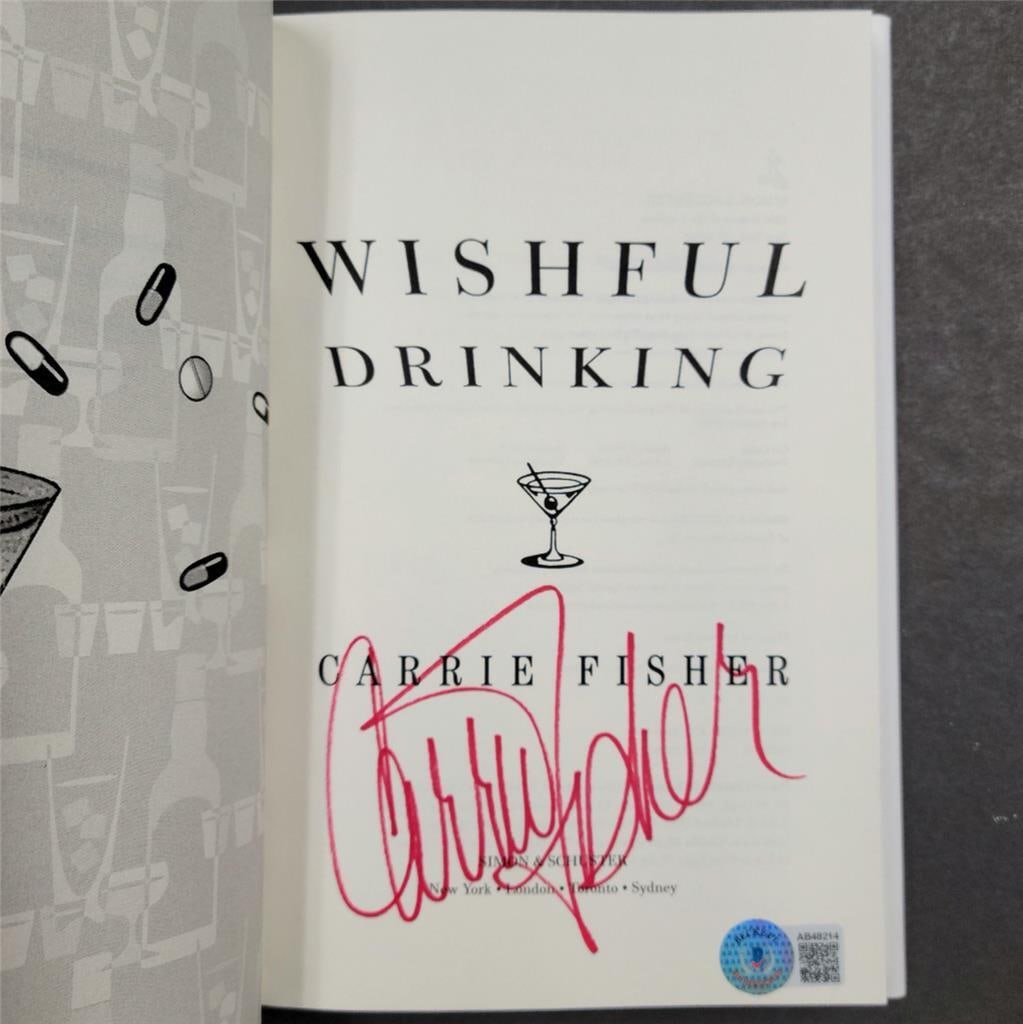 Wishful Drinking first edition book signed by Carrie Fisher with Beckett COA: Wishful Drinking first edition book signed by Carrie Fisher with Beckett COA First edition copy of Wishful Drinking signed by Carrie Fisher. This original autograph has been authenticated by Beckett.