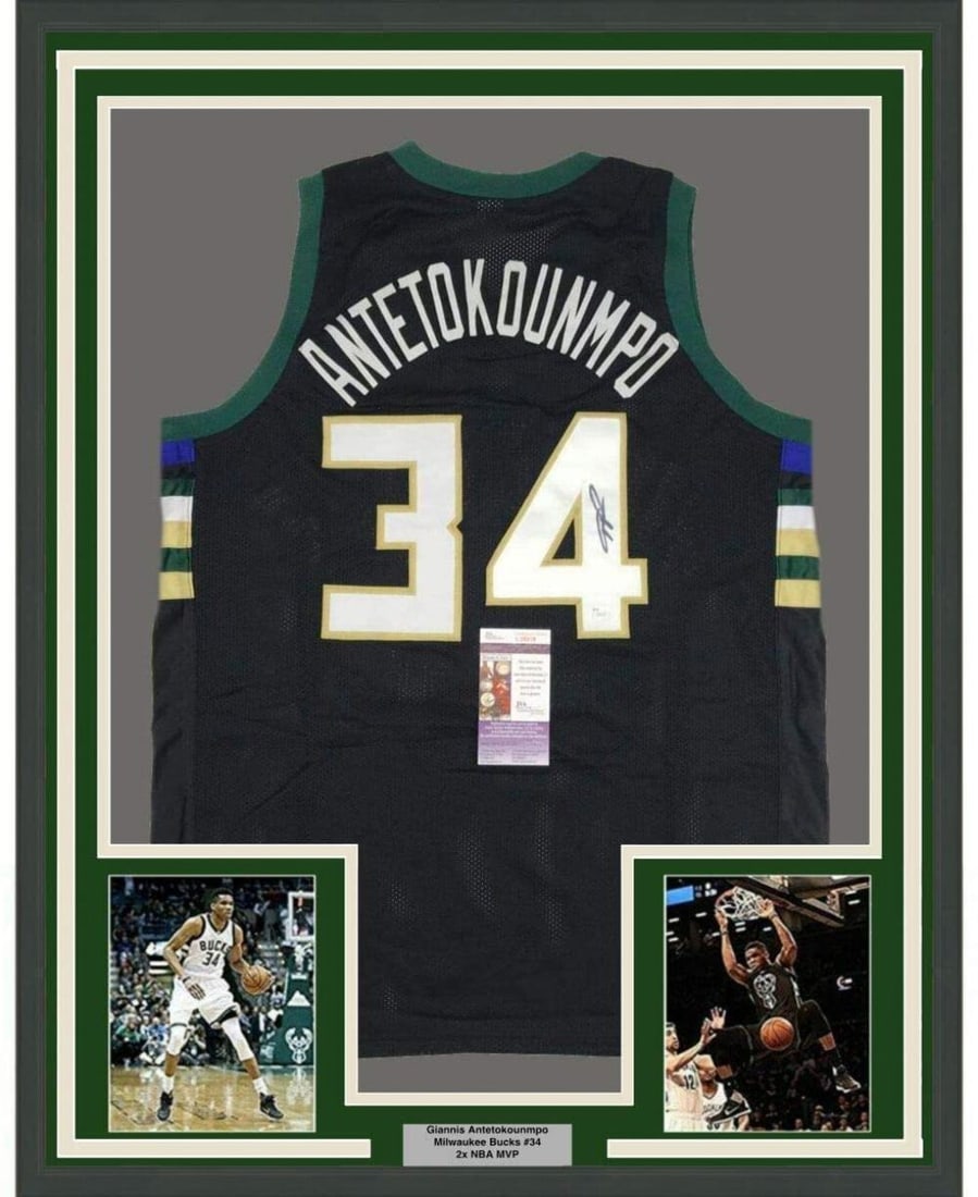 Framed Autographed Giannis Antetokounmpo Jersey 33x42 with JSA COA: Framed Autographed Giannis Antetokounmpo Jersey 33x42 with JSA COA This professionally framed and matted display features an autographed black jersey of NBA superstar Giannis Antetokounmpo. Measuring